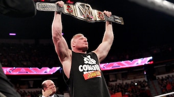Brock Lesnar celebrates with the world title.