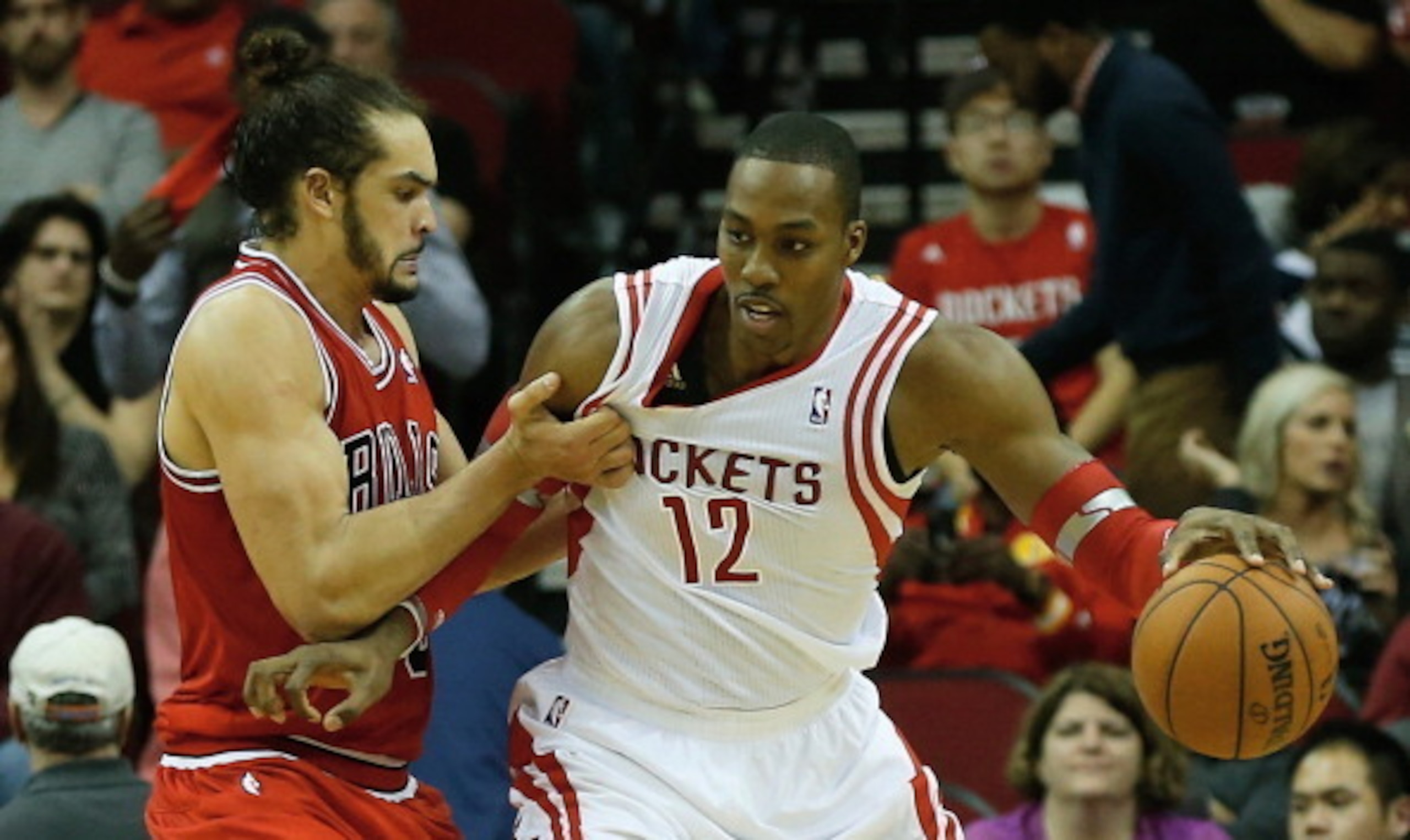 HOUSTON, TX - DECEMBER 18:   Dwight Howard #12 of the Houston Rockets is grabbed unber the basket by Joakim Noah #13 of the Chicago Bulls during the game at Toyota Center on December 18, 2013 in Houston, Texas. NOTE TO USER: User expressly acknowledges an