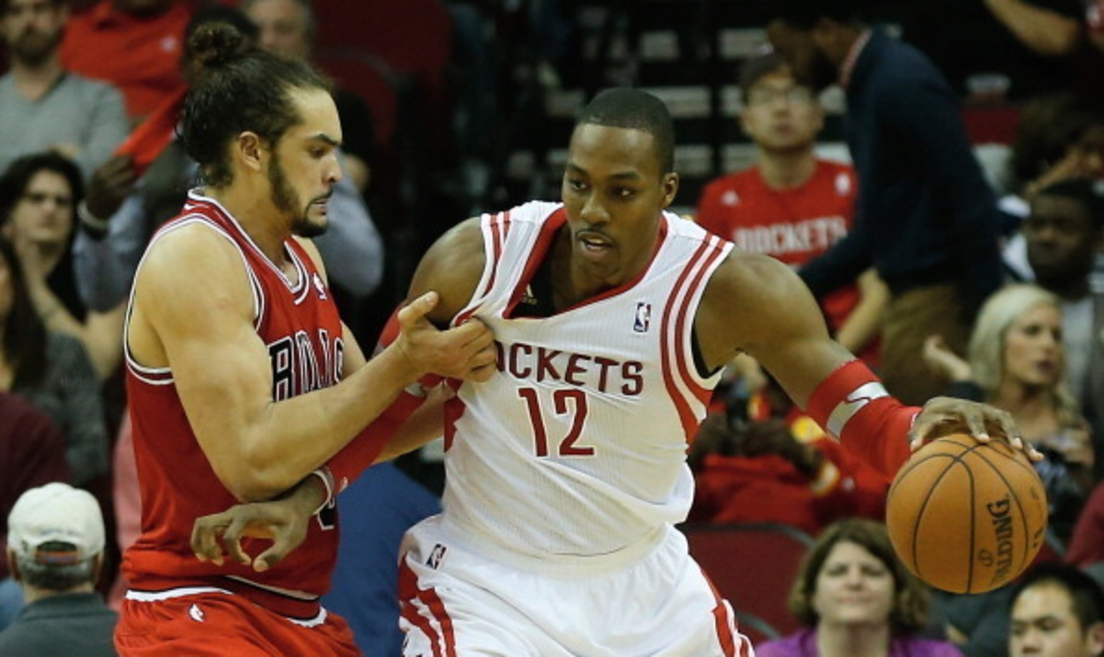 HOUSTON, TX - DECEMBER 18:   Dwight Howard #12 of the Houston Rockets is grabbed unber the basket by Joakim Noah #13 of the Chicago Bulls during the game at Toyota Center on December 18, 2013 in Houston, Texas. NOTE TO USER: User expressly acknowledges an