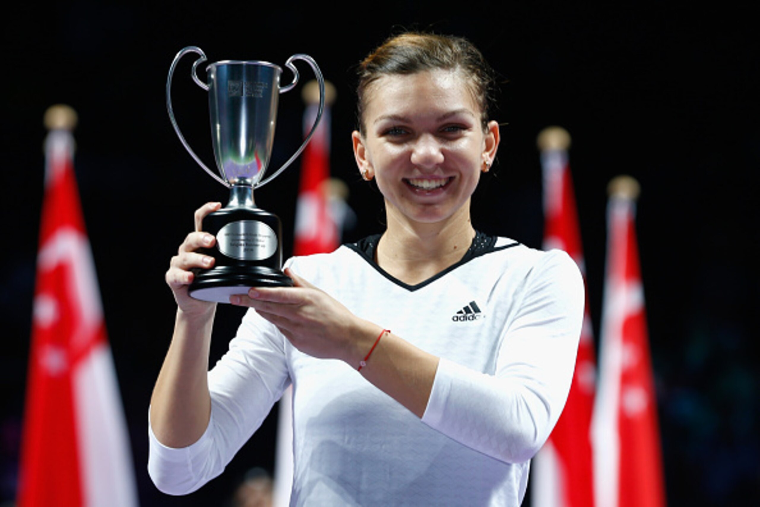 Simona Halep shows off the runner-up trophy at the 2014 WTA Championships.