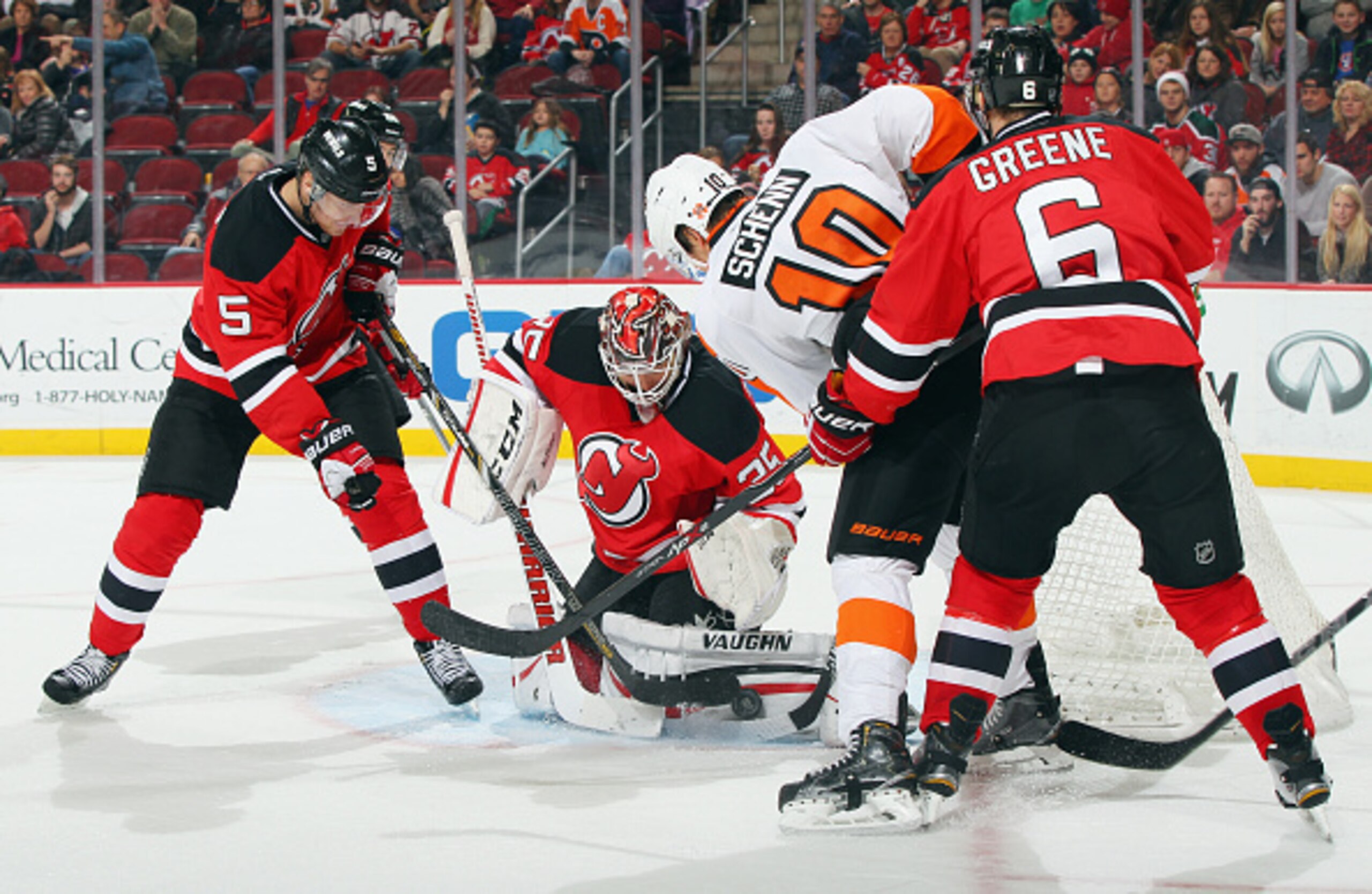 Andy Greene and Adam Larsson, two key players on the penalty kill, fight for a loose puck in front of the net.