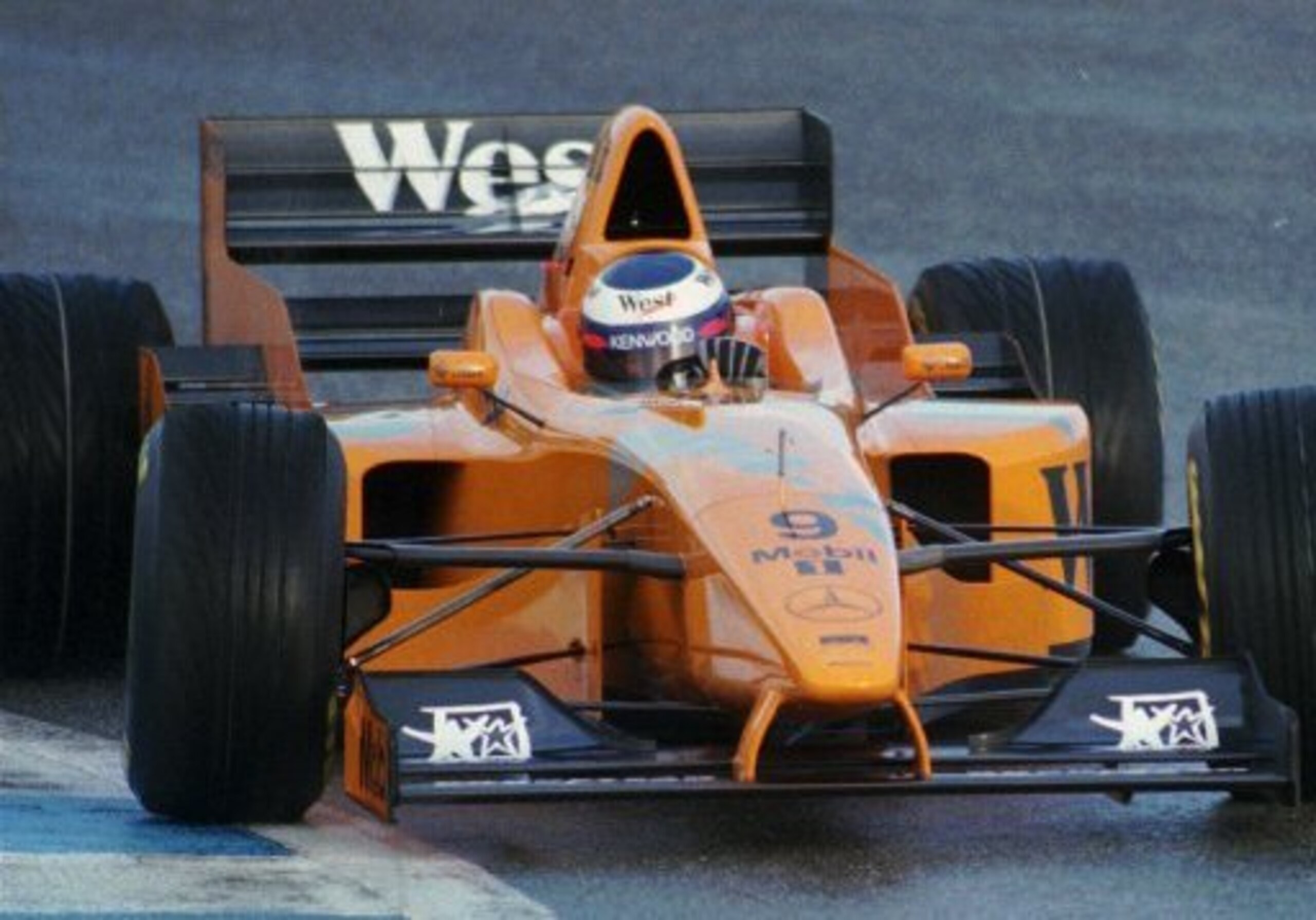 An orange McLaren testing in 1997.