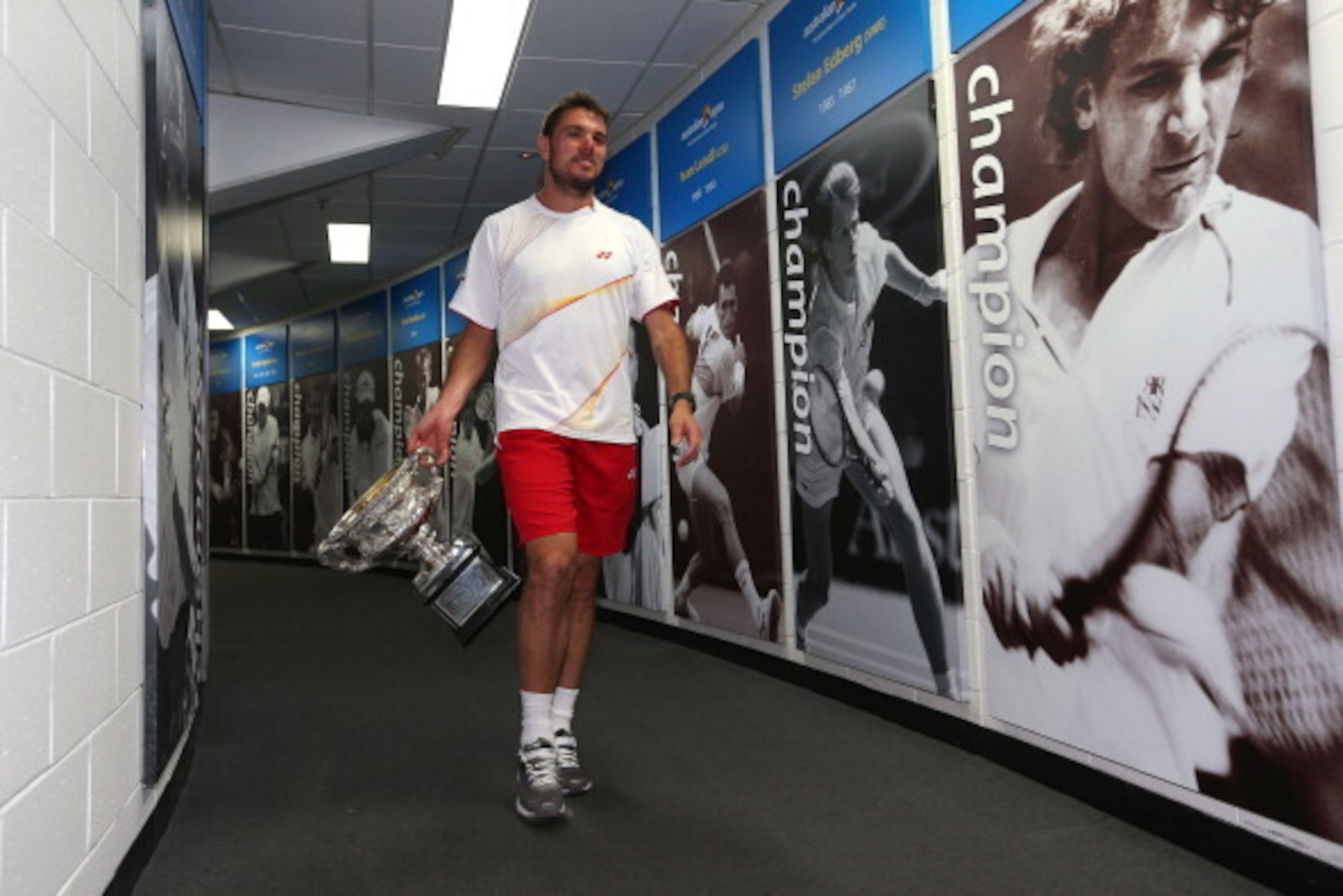 Stan Wawrinka, winner of the 2014 Australian Open, walks past wall of past champions.