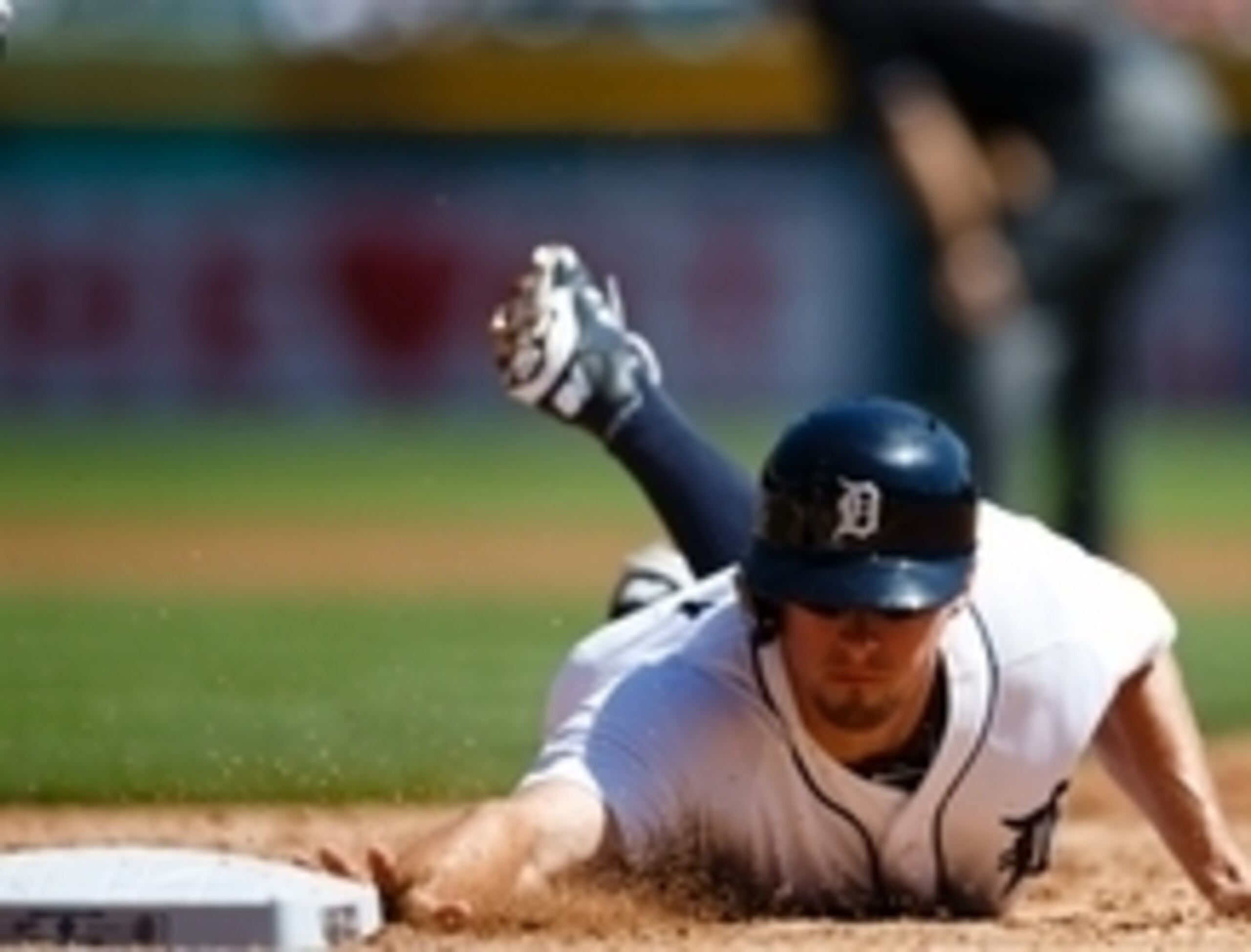 Aug 28, 2014; Detroit, MI, USA; Detroit Tigers player Don Kelly (32) dives back to first against the New York Yankees at Comerica Park. Mandatory Credit: Rick Osentoski-USA TODAY Sports