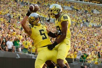 FILE - In this Sept. 6, 2014, file photo, Oregon's Devon Allen, left, celebrates with teammate Dwayne Stanford after scoring in the 3rd quarter against Michigan State in their NCAA college football game in Eugene, Ore. These all-yellow uniforms have been 