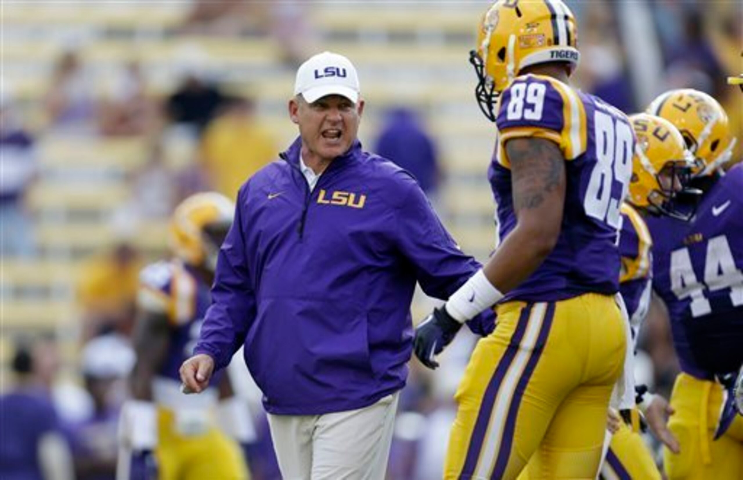 LSU tight end DeSean Smith (No. 89) receives instruction from LSU head coach Les Miles (left).