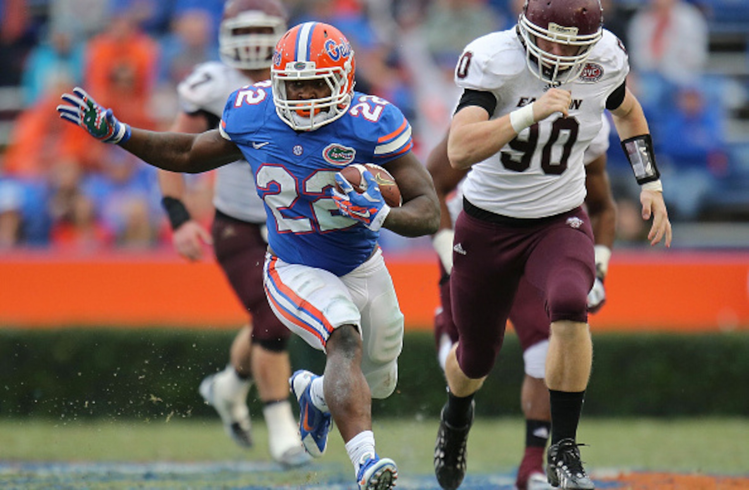 GAINESVILLE, FL - NOVEMBER 22: Adam Lane #22 of the Florida Gators carries past defender Robby Irgang #90 of the Eastern Kentucky Colonels of the game at Ben Hill Griffin Stadium on November 22, 2014 in Gainesville, Florida.  (Photo by Rob Foldy/Getty Ima