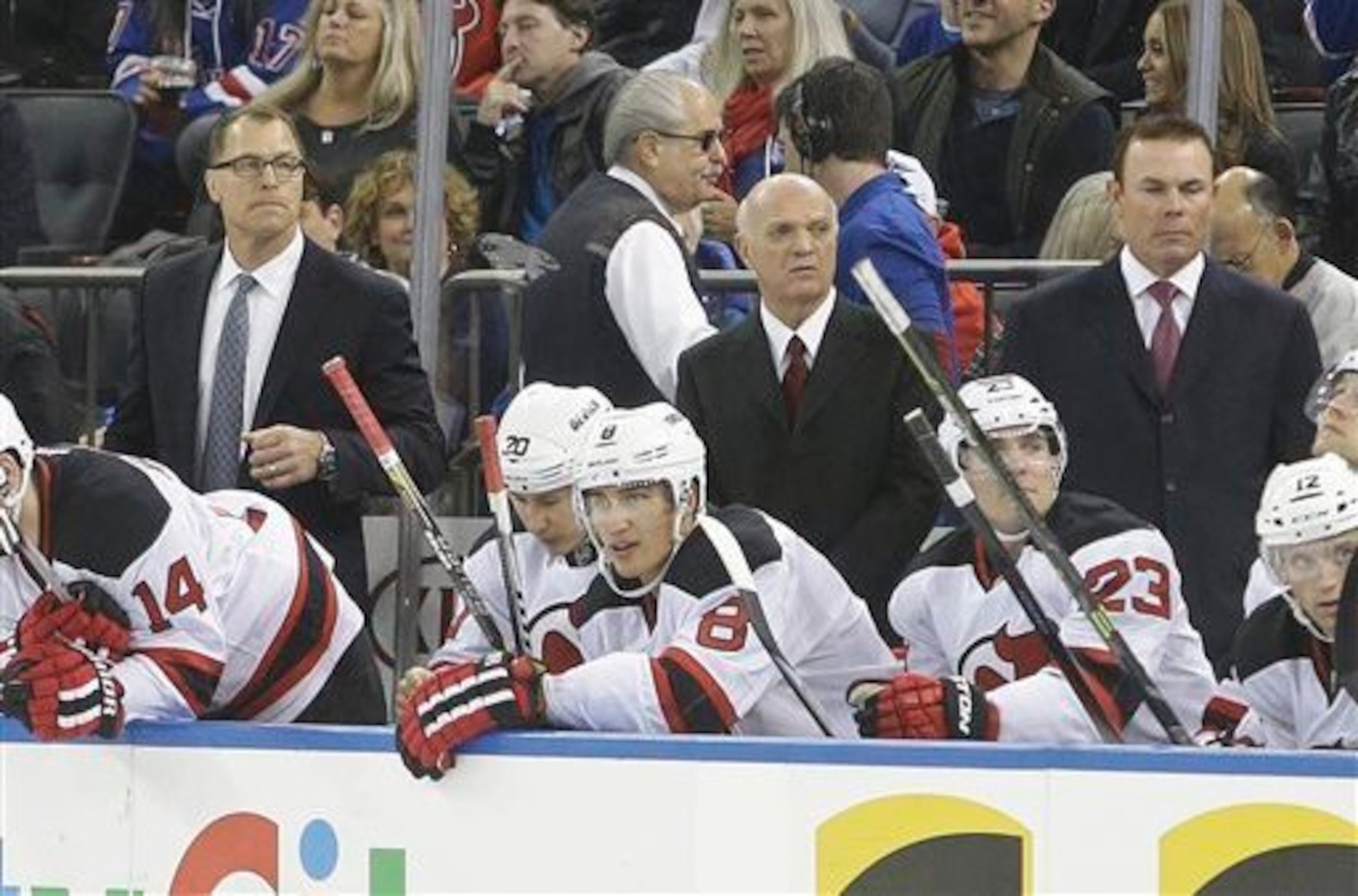 The temporary Devils coaching staff looks on during a game. The temporary Devils coaching staff looks on during a game.