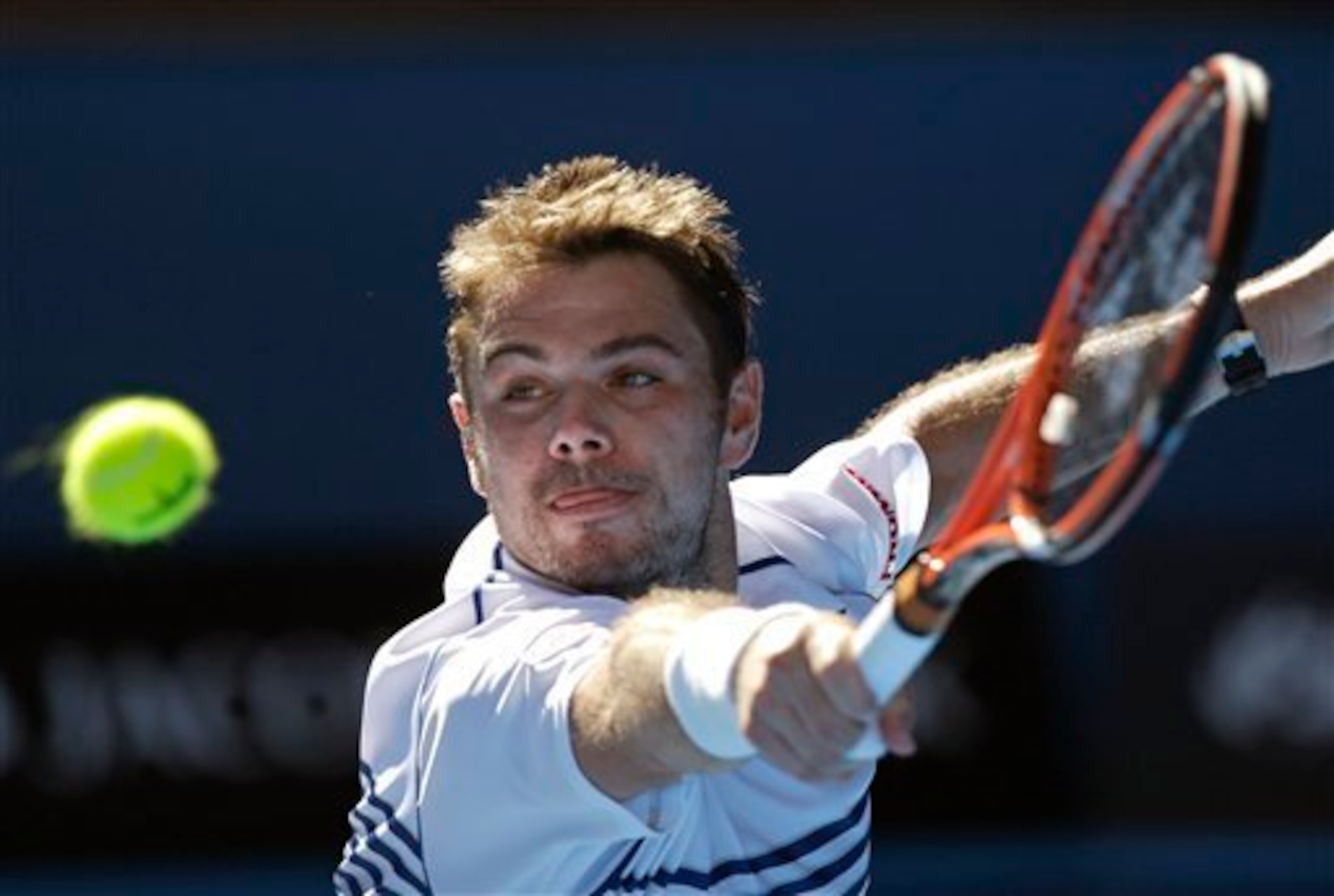 Stan Wawrinka hits a backhand volley during an early-round match at the 2015 Australian Open.