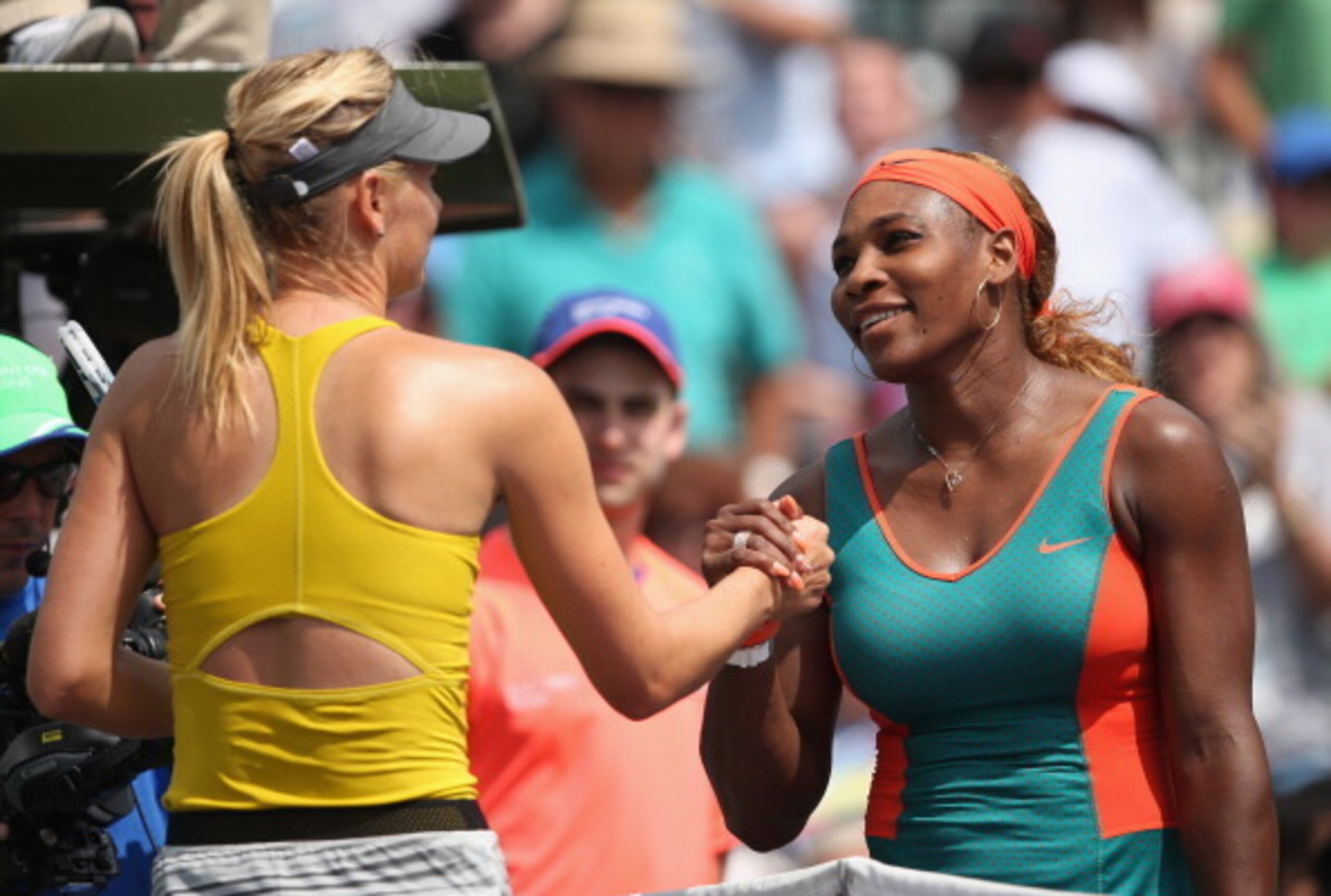Maria Sharapova and Serena Williams shake hands at the net after a match at the 2014 Sony Open in Miami.