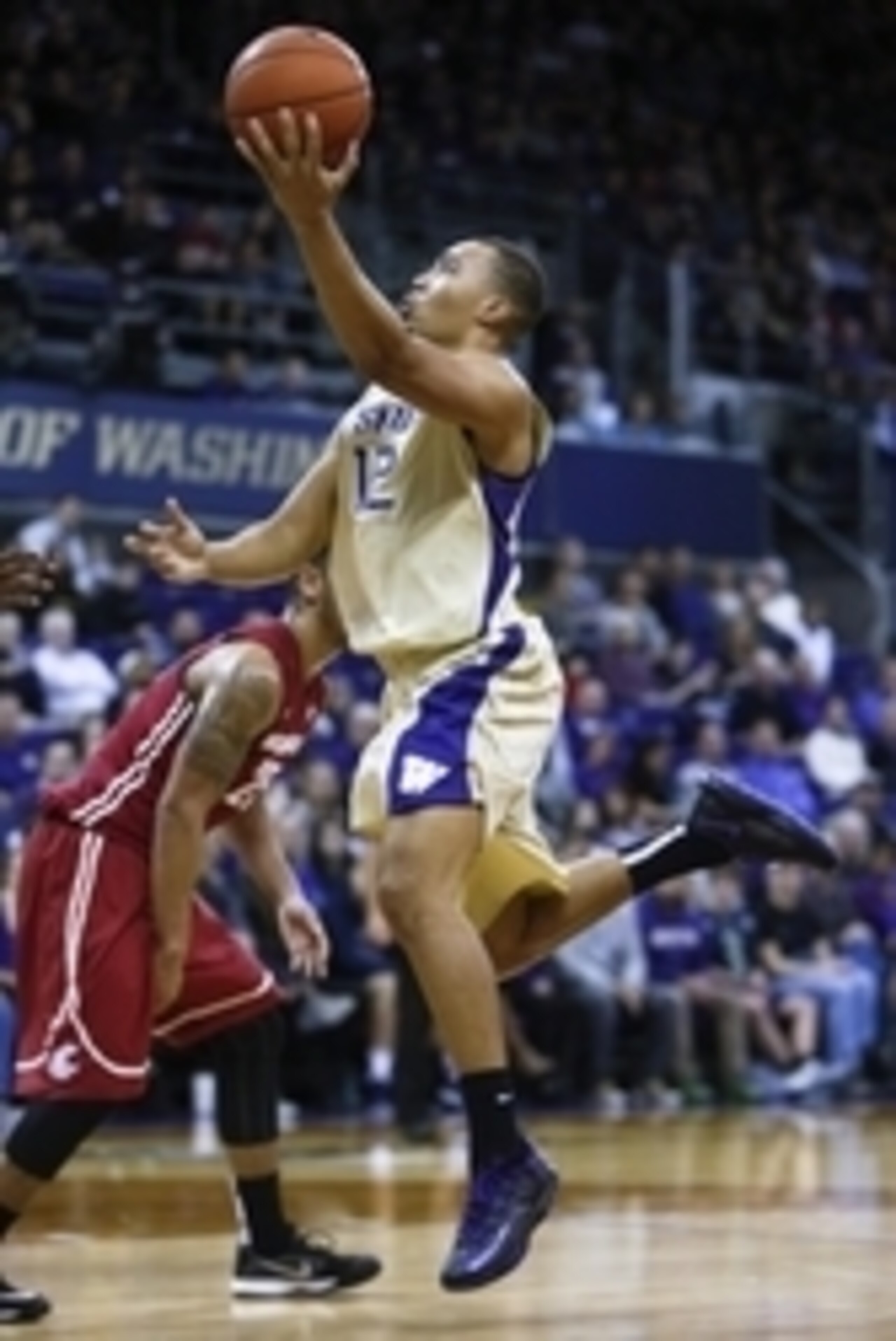 Jan 10, 2015; Seattle, WA, USA; Washington Huskies guard Andrew Andrews (12) drives the lane for a layup against the Washington State Cougars during the first half at Alaska Airlines Arena. Mandatory Credit: Jennifer Buchanan-USA TODAY Sports