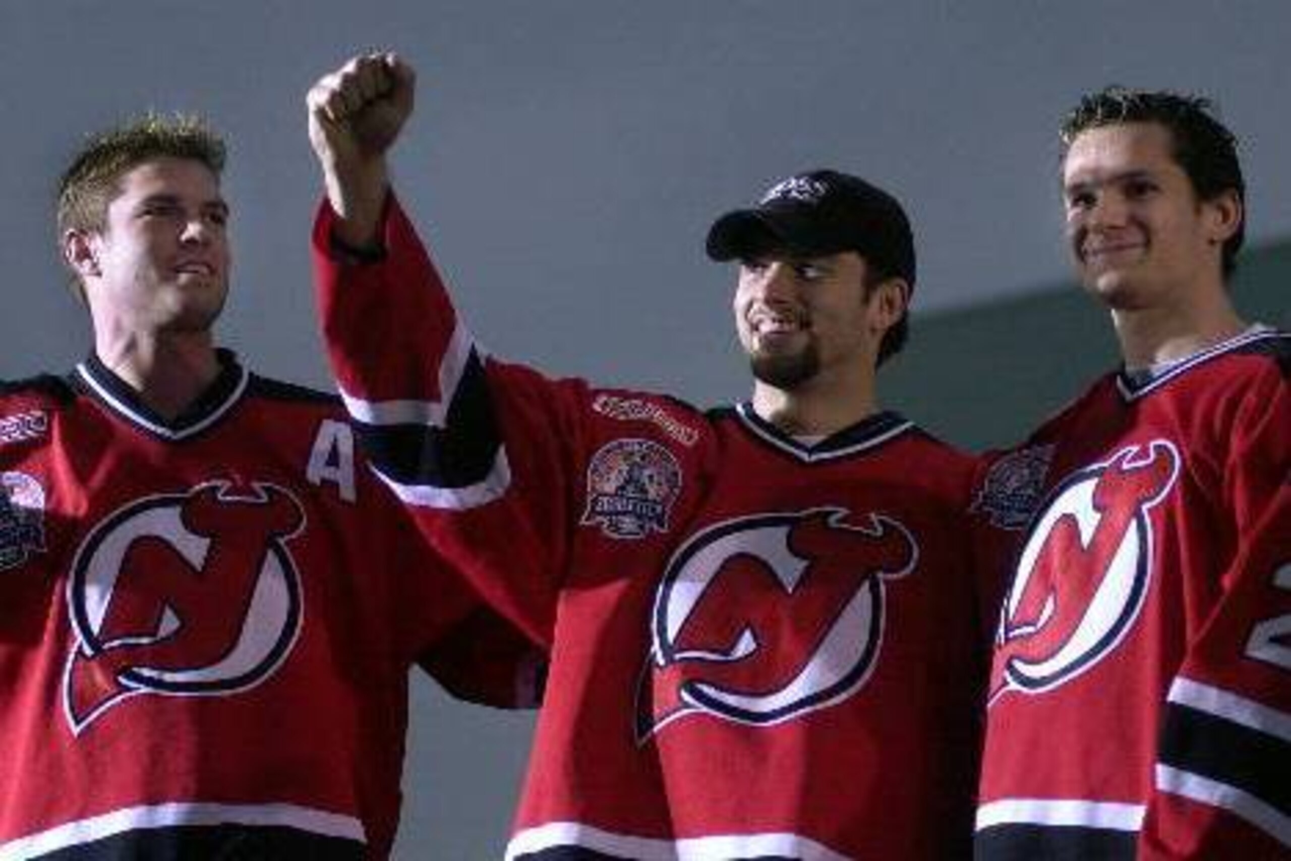 Jason Arnott, Petr Sykora and Patrik Elias pose for a photo during a 2000 Stanley Cup celebration. Sykora and Elias are both European.