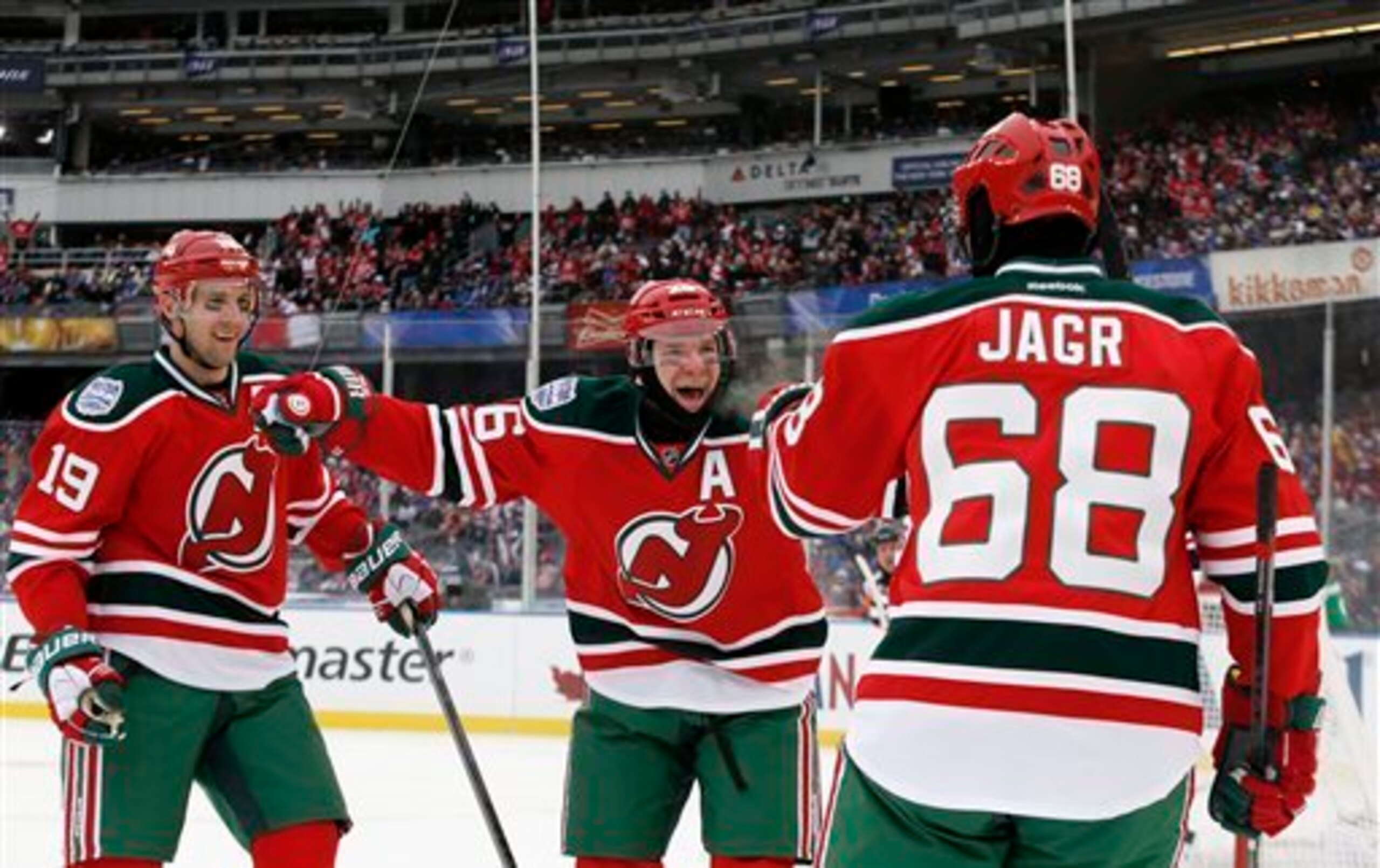 Jaromir Jagr celebrates a goal with Travis Zajac and Patrik Elias during the Devils' Stadium Series Game in January 2014.