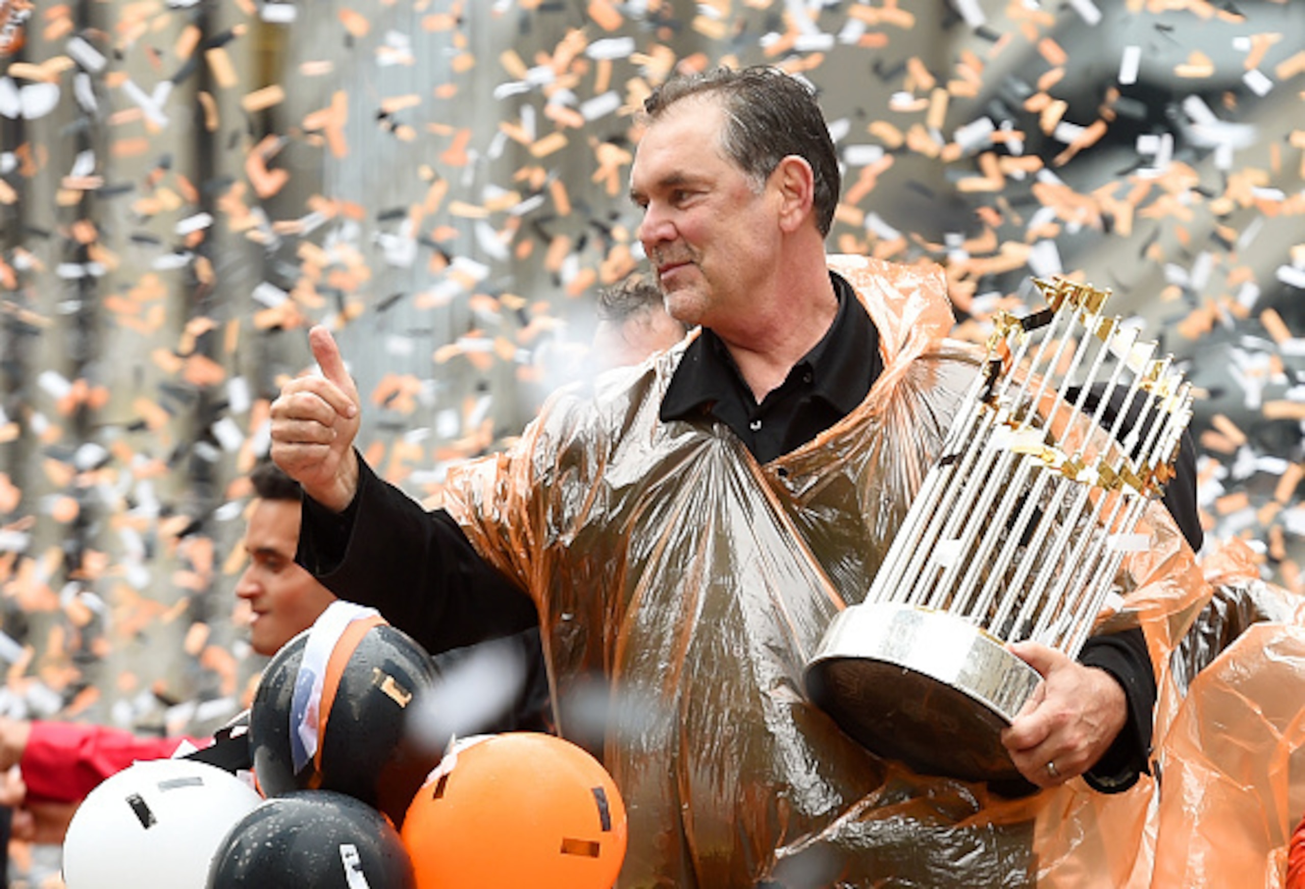 Bruce Bochy celebrates and shows off the World Series trophy at the Giants victory parade.