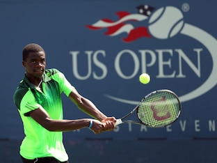 Francis Tiafoe hits a backhand at the 2014 U.S. Open.