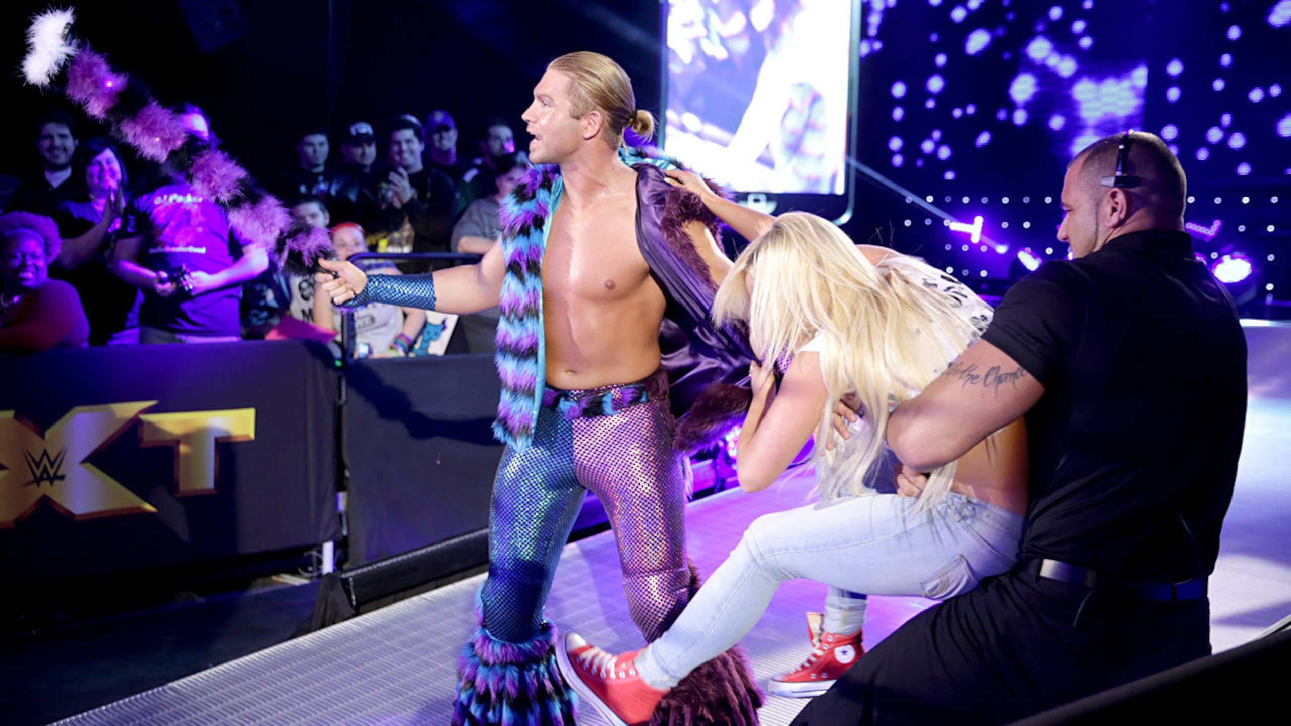 Tyler Breeze gets attacked by a fan before his match with Hideo Itami
