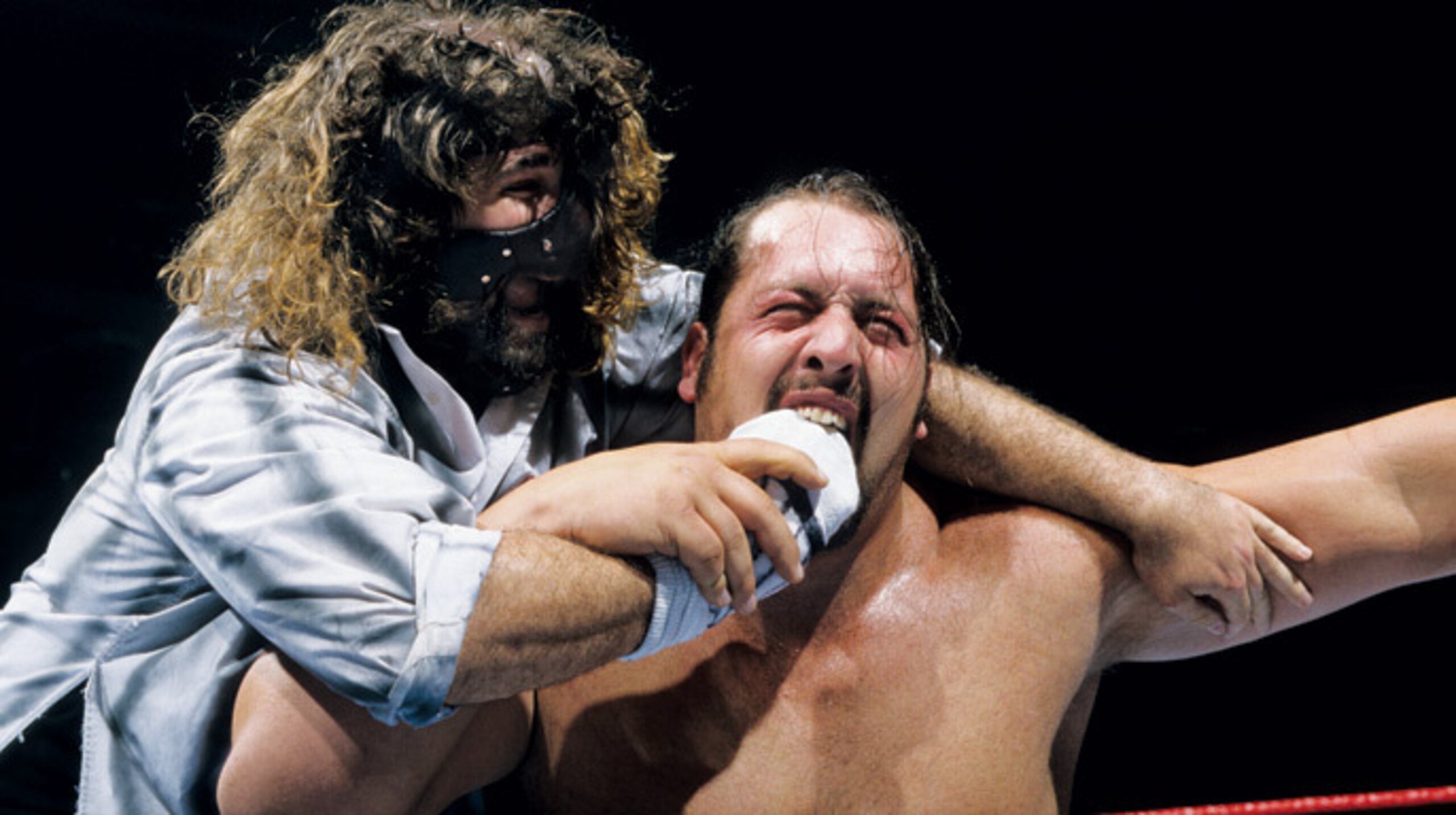 Mankind puts the Mandible Claw on Paul Wight.