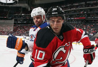 Peter Harrold makes a play along the boards against the Edmonton Oilers. Can the Devils find an upgrade over Harrold and Mark Fraser?