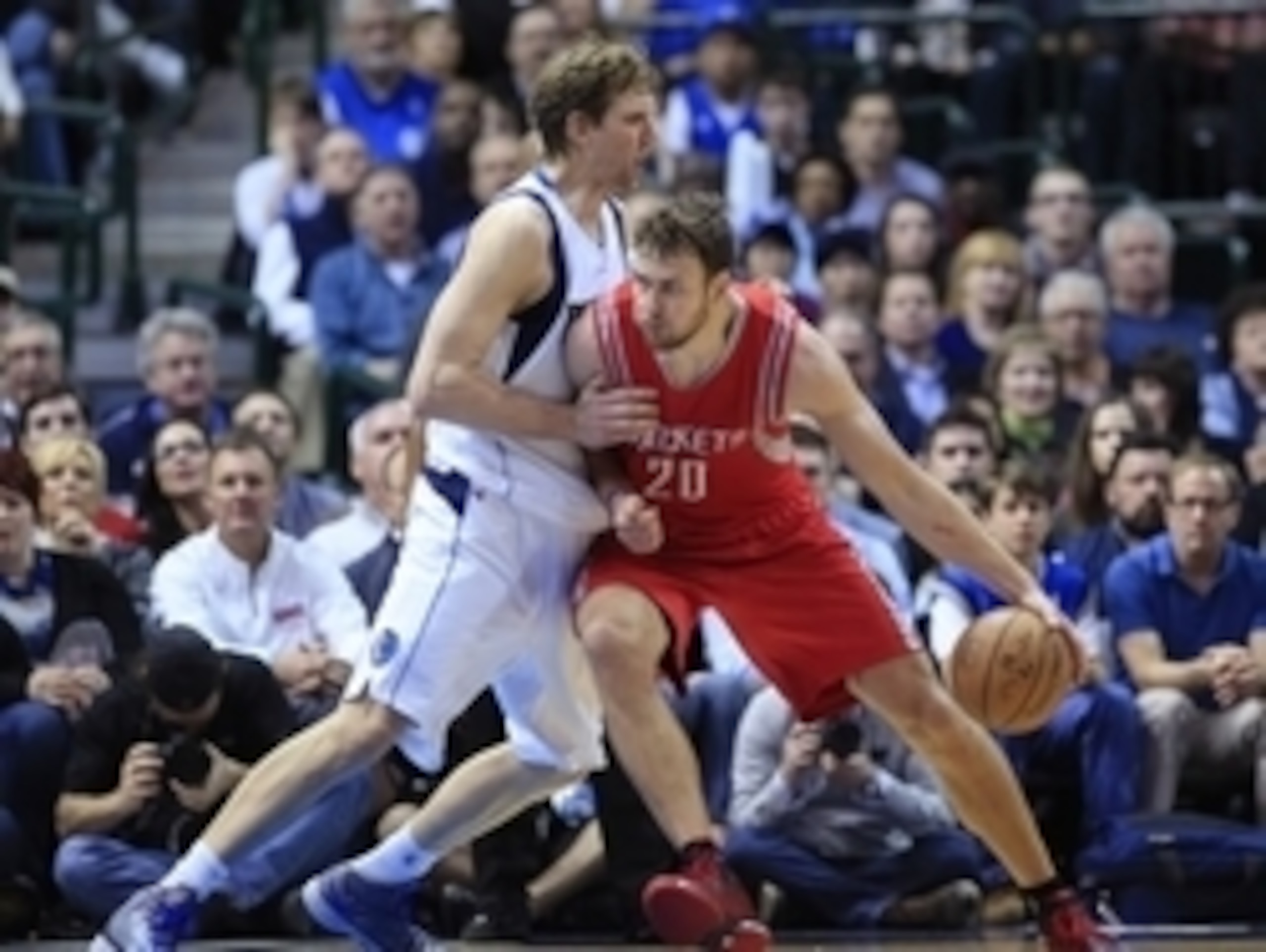 Feb 20, 2015; Dallas, TX, USA; Houston Rockets forward Donatas Motiejunas (20) dribbles as Dallas Mavericks forward Dirk Nowitzki (41) defends during the game at American Airlines Center. Mandatory Credit: Kevin Jairaj-USA TODAY Sports