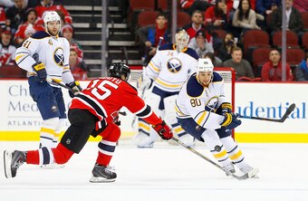 Chris Stewart and Tuomo Ruutu reach for a loose puck.