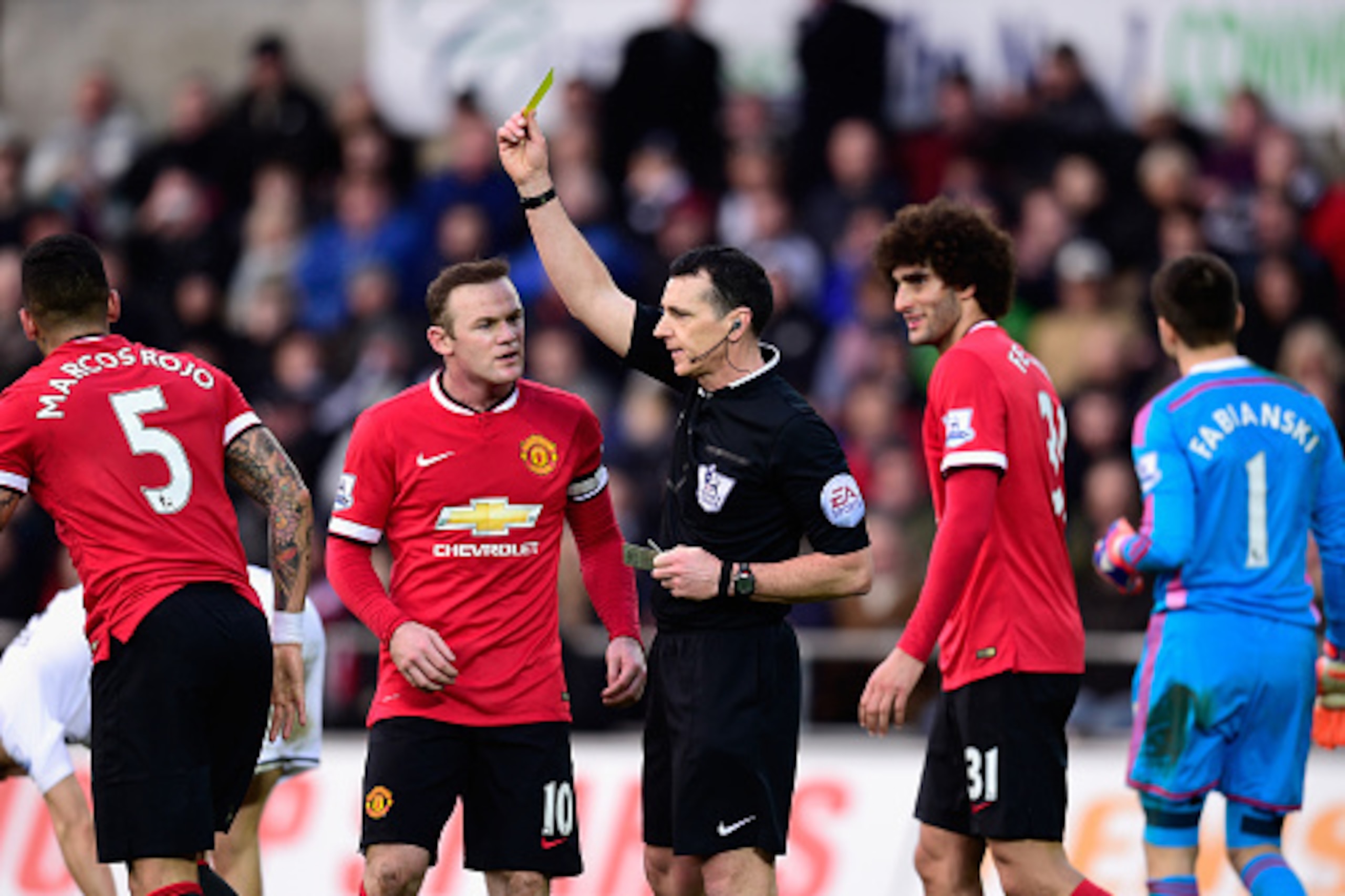 Marcos Rojo is booked against Swansea City