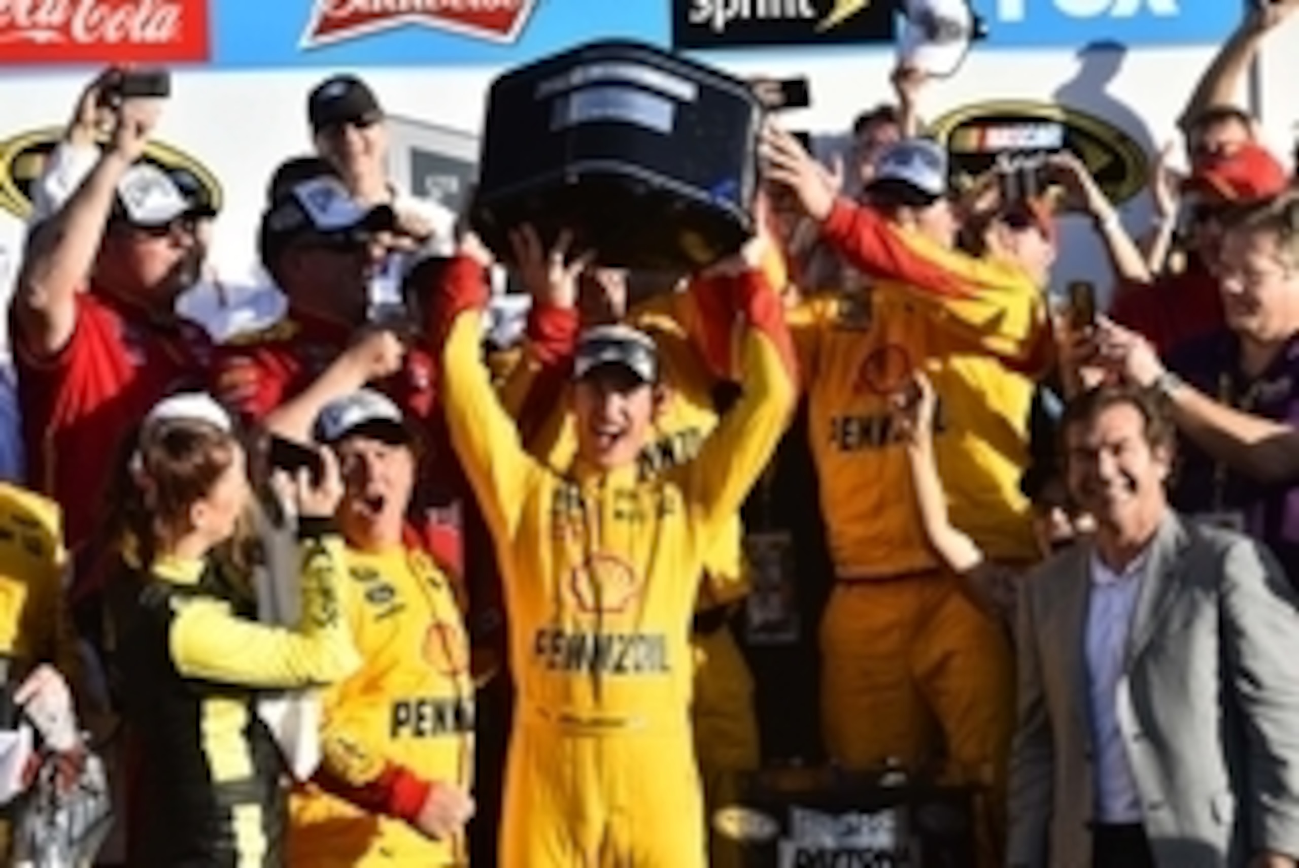 Joey Logano hoists the Daytona 500 trophy.