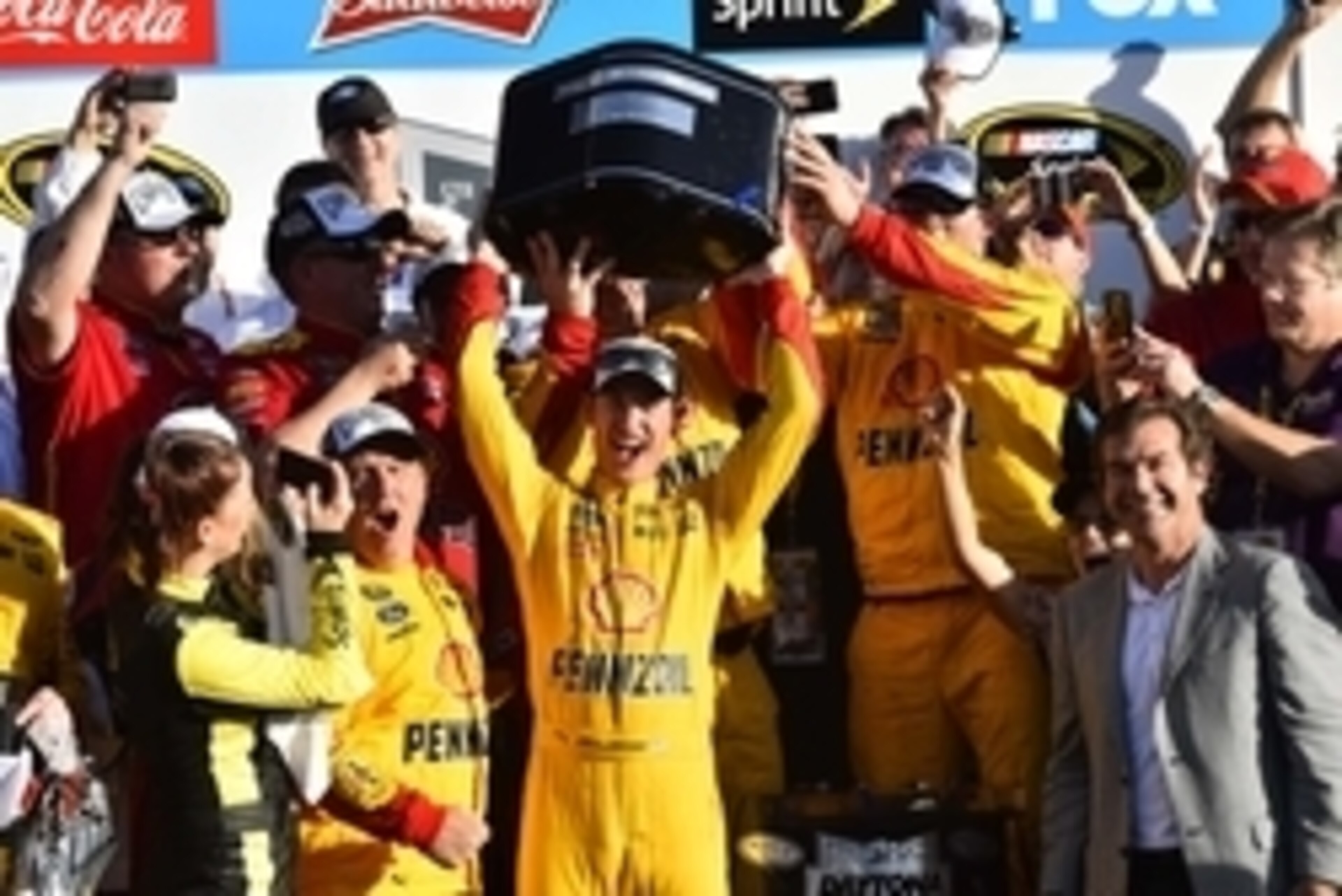 Joey Logano hoists the Daytona 500 trophy.