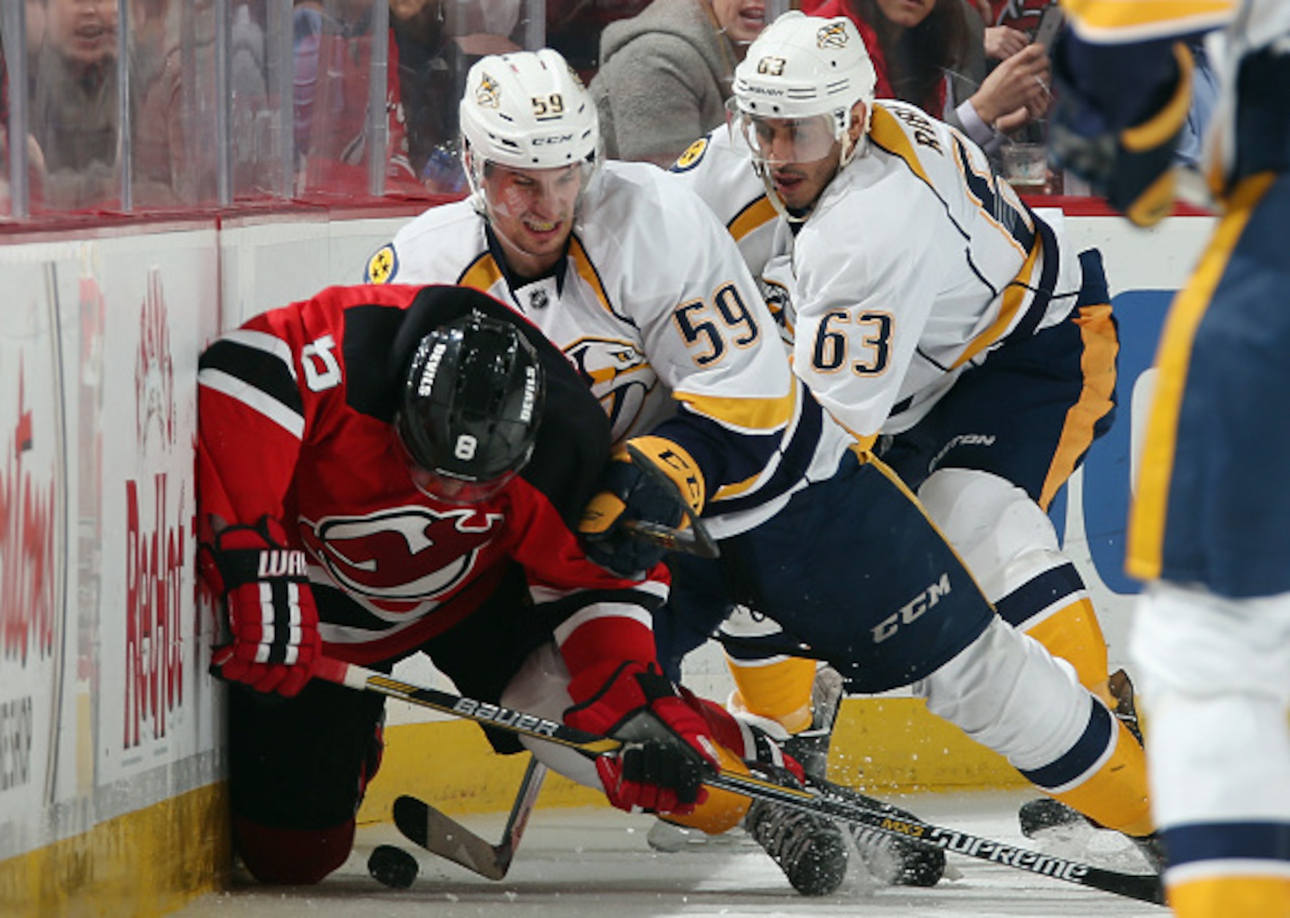 Dainius Zubrus fights for the puck along the boards. Dainius Zubrus fights for the puck along the boards.