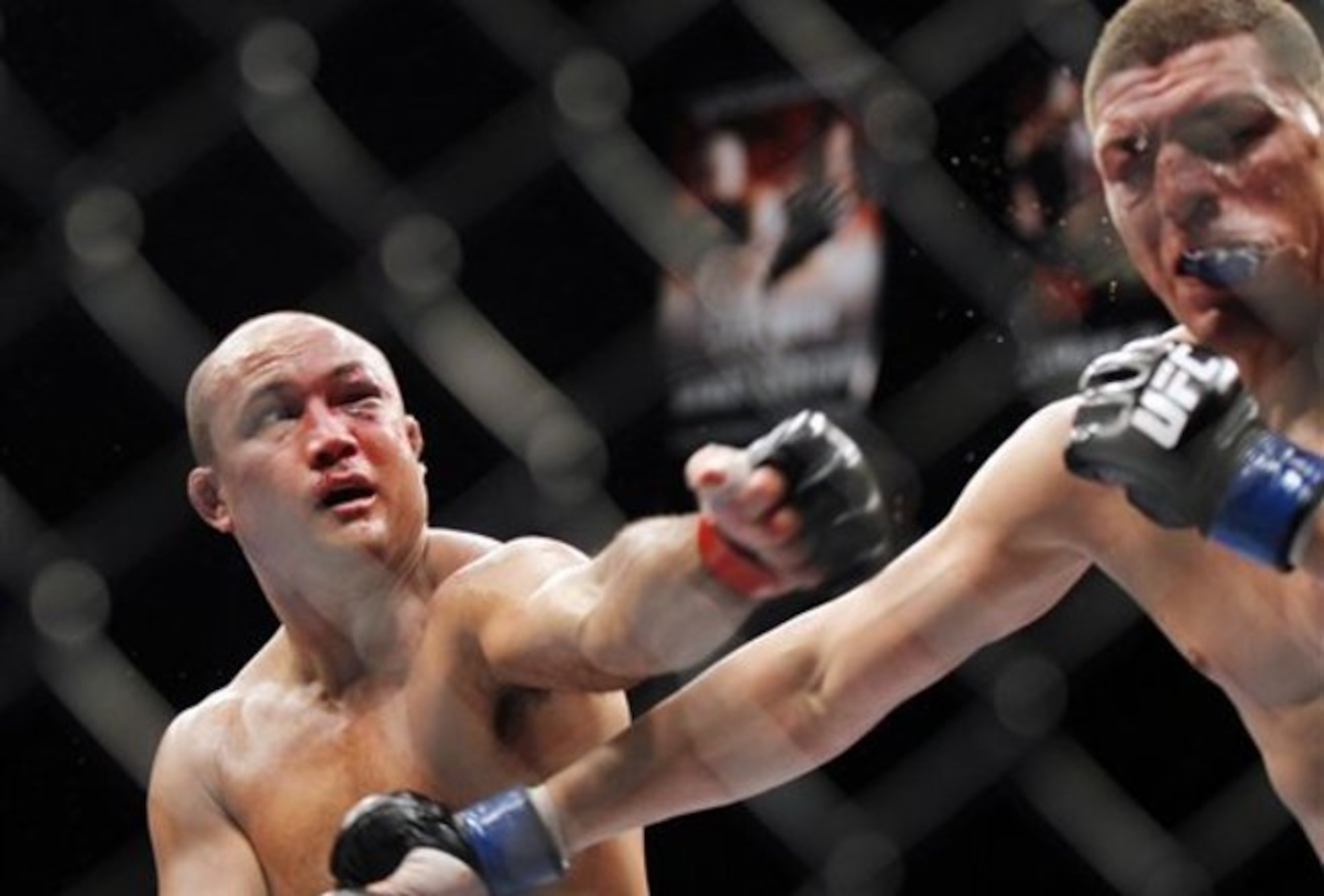 BJ Penn (L) blasts Nkick Diaz (R), almost knocking out his mouthpiece