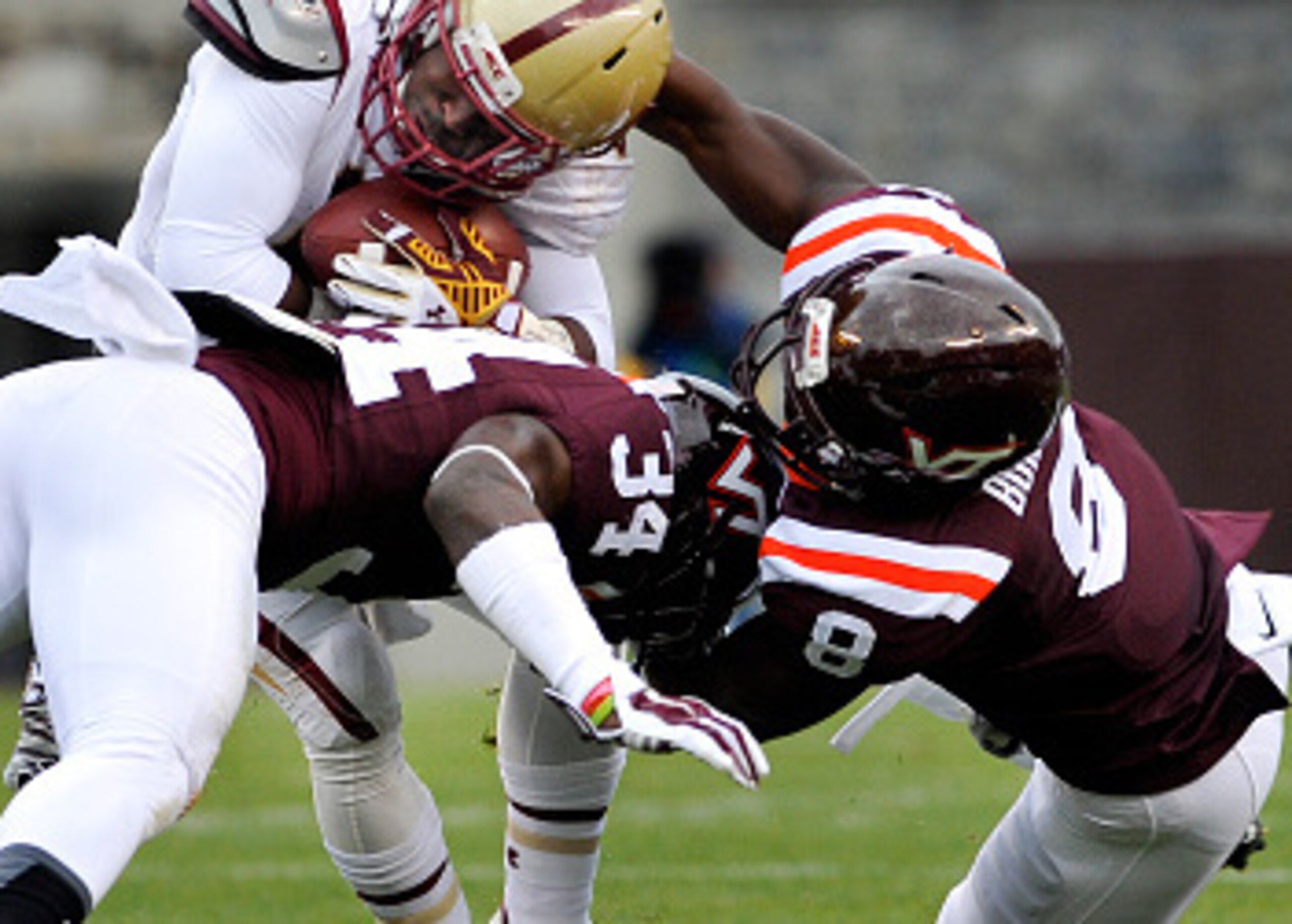 Kyshoen Jarrett and Detrick Bonner take down a Boston College runner in 2014