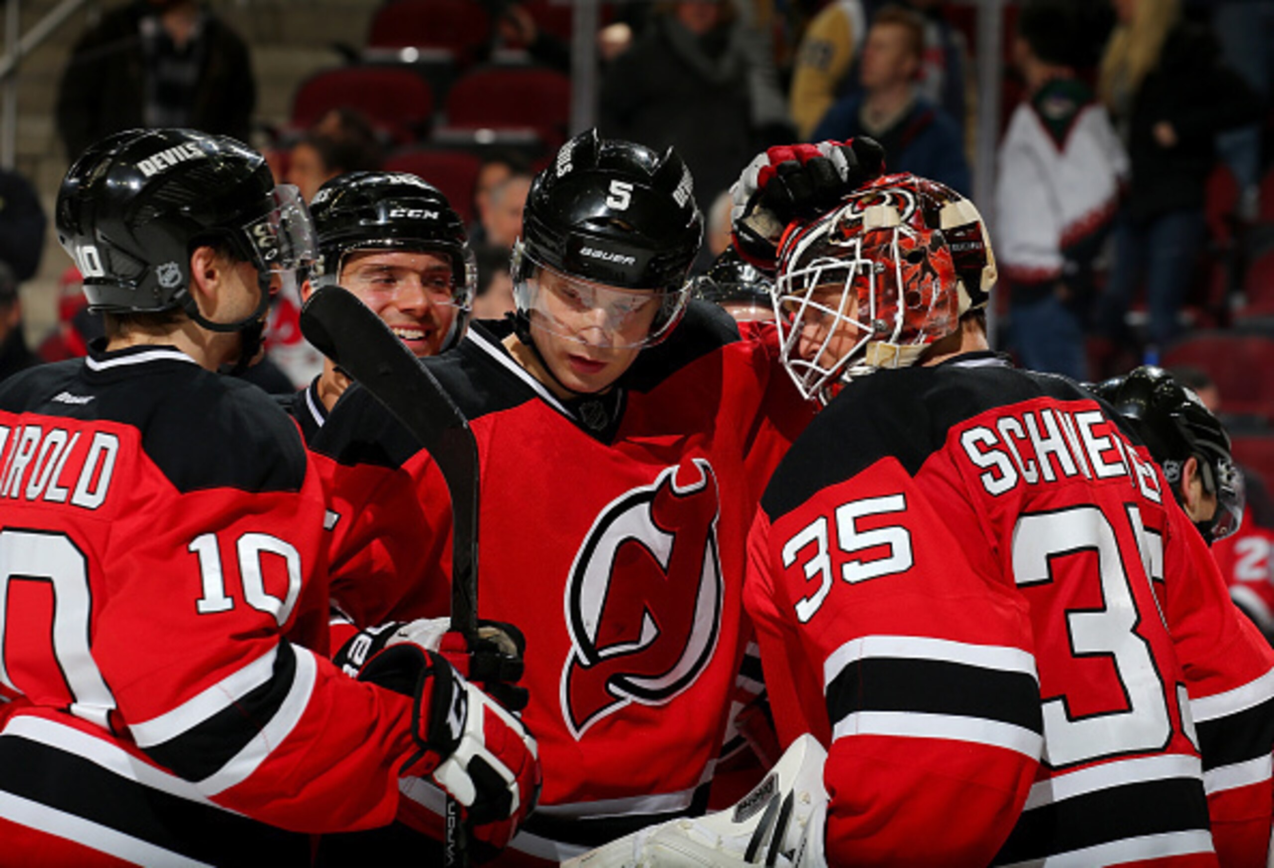 Adam Larsson (center) celebrates a victory with his teammates.