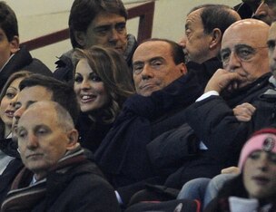 Berlusconi (center) is increasingly reported to be selling at least part of the team.