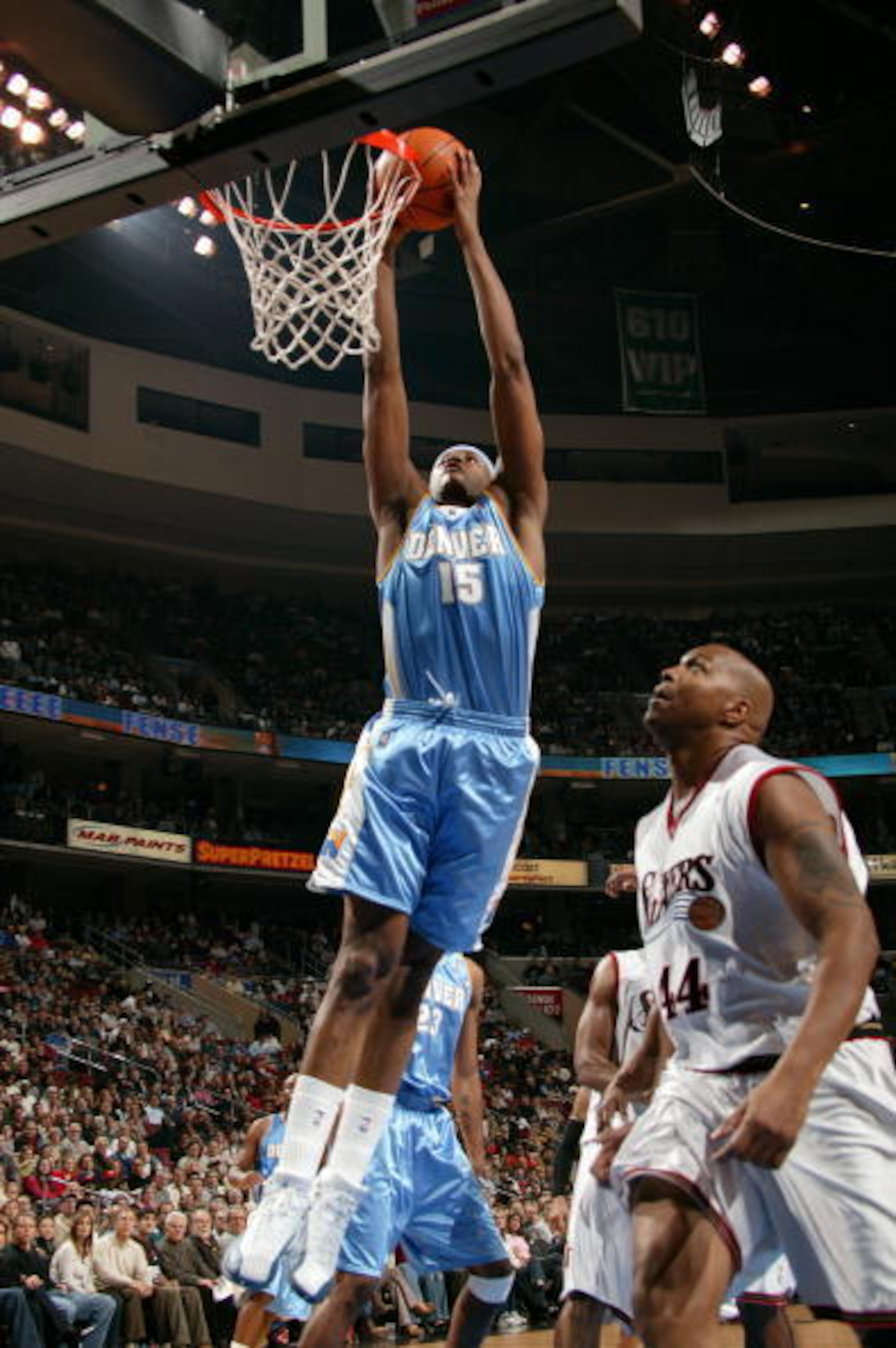 Carmelo Anthony dunks as Derrick Coleman takes in the view.