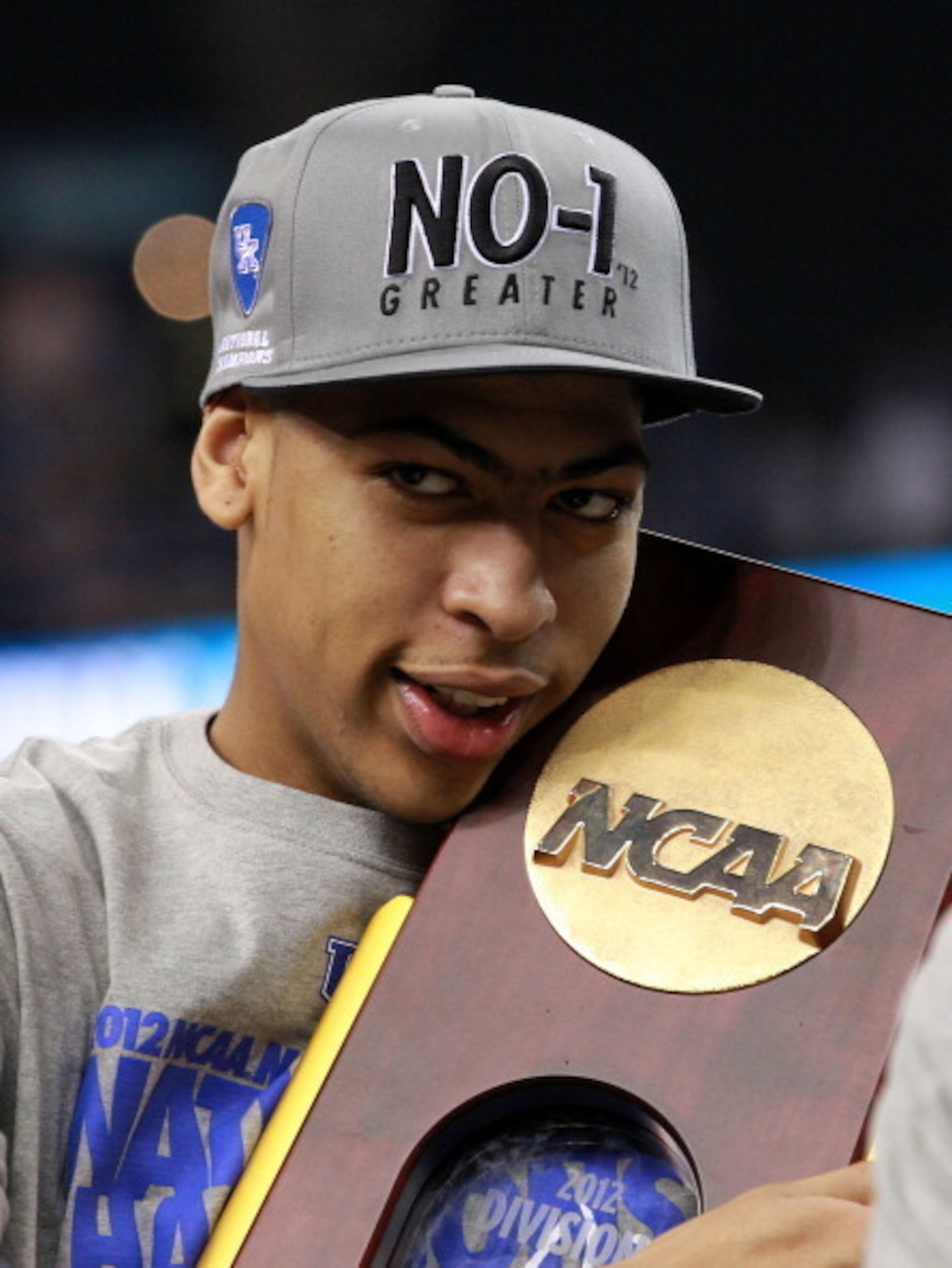 Anthony Davis clutches the Wooden NCAA Championship trophy.