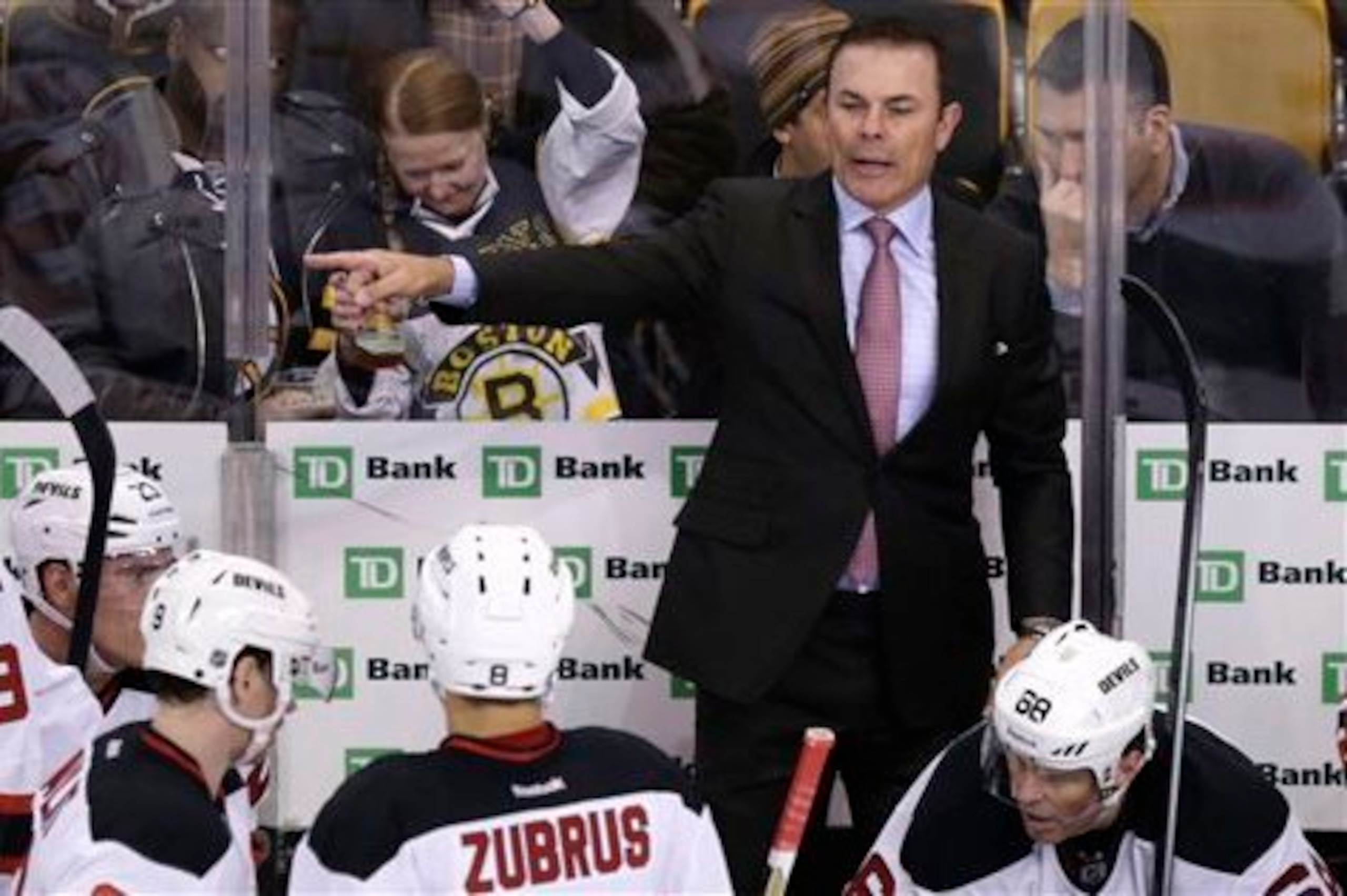 Adam Oates gives direction to Dainius Zubrus from the bench.