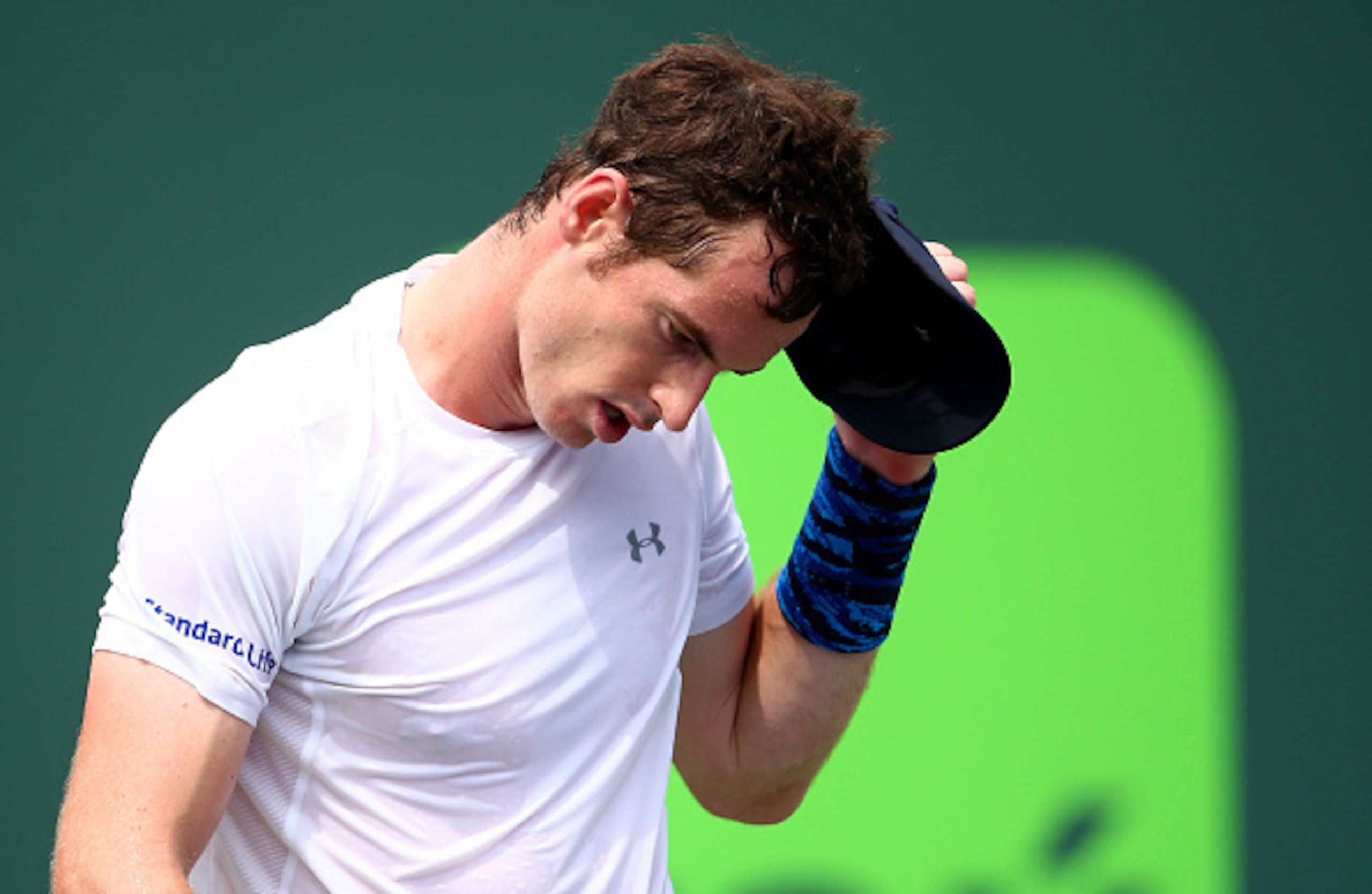 KEY BISCAYNE, FL - MARCH 27:  Andy Murray of Great Britain removes his cap after his straight sets victory against Donald Young of the United States in their second round match during the Miami Open Presented by Itau at Crandon Park Tennis Center on March