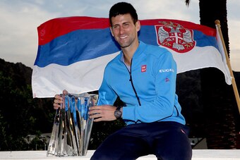 Novak Djokovic poses with his Indian Wells trophy.
