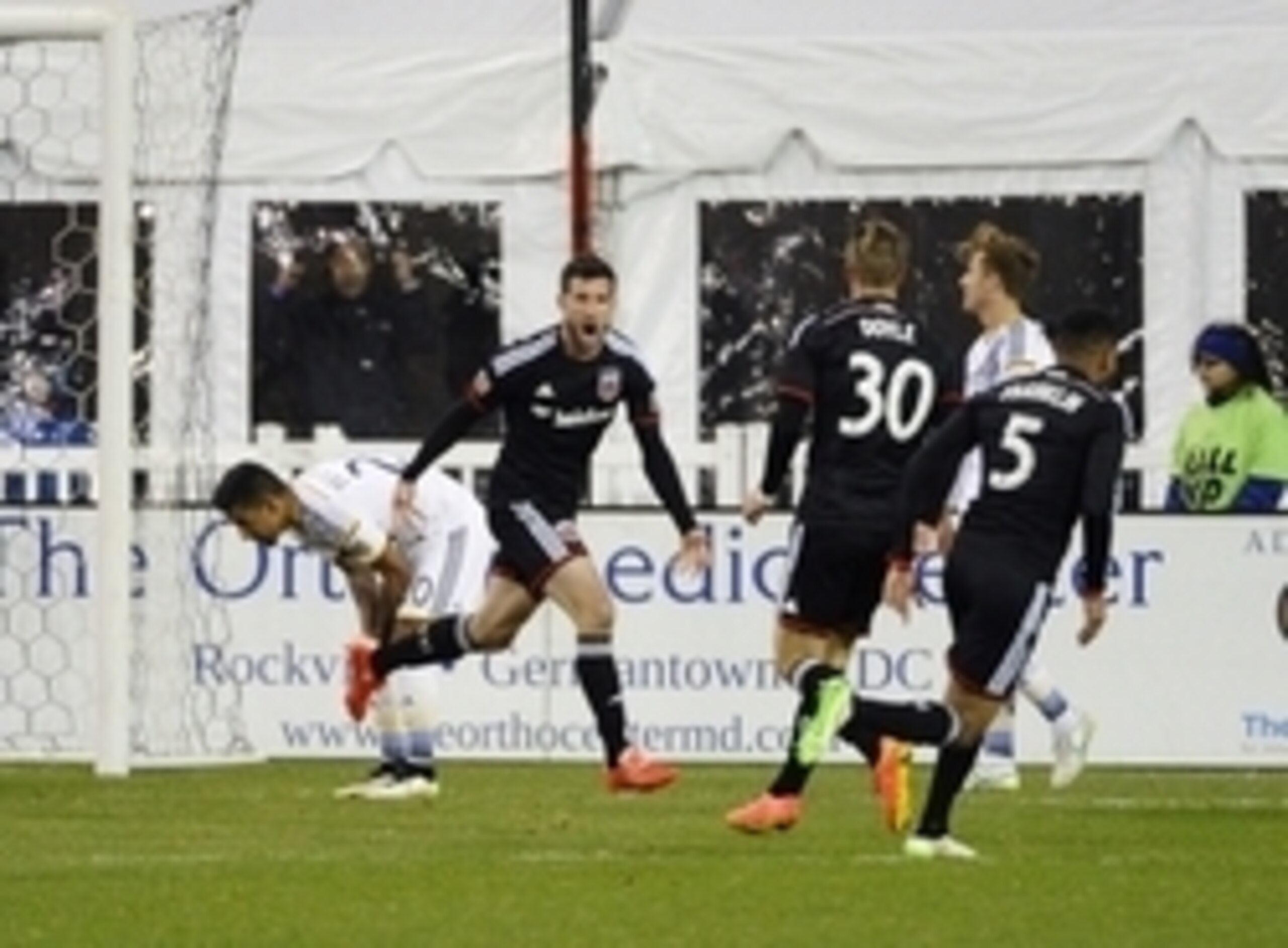 Mar 28, 2015; Washington, DC, USA; D.C. United midfielder/forward Chris Pontius (13) is congratulated by teammates after scoring a goal against the Los Angeles Galaxy during the second half  at Robert F. Kennedy Memorial. Mandatory Credit: Brad Mills-USA 