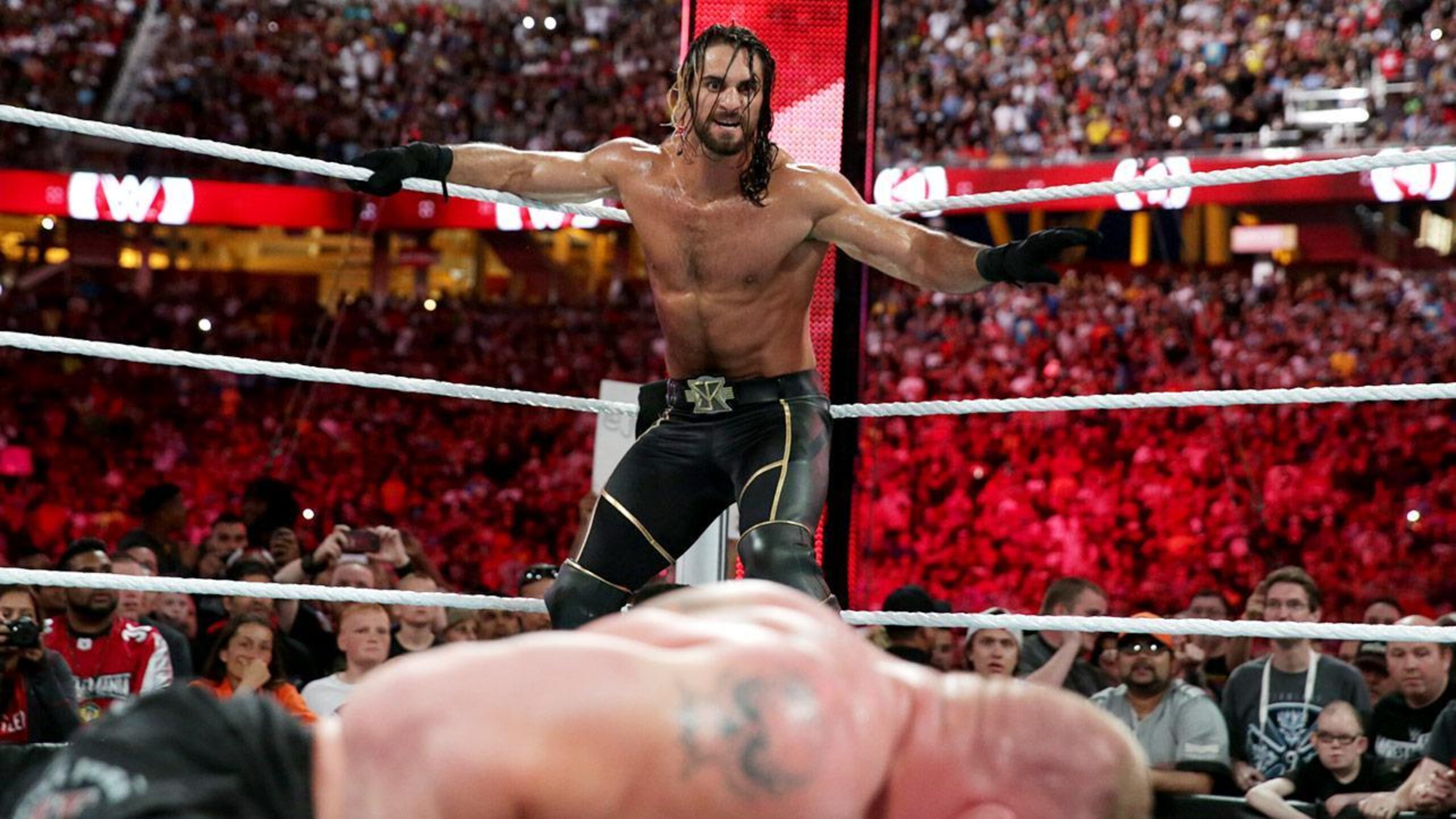Seth Rollins looks to pounce on Brock Lesnar. Seth Rollins looks to pounce on Brock Lesnar.