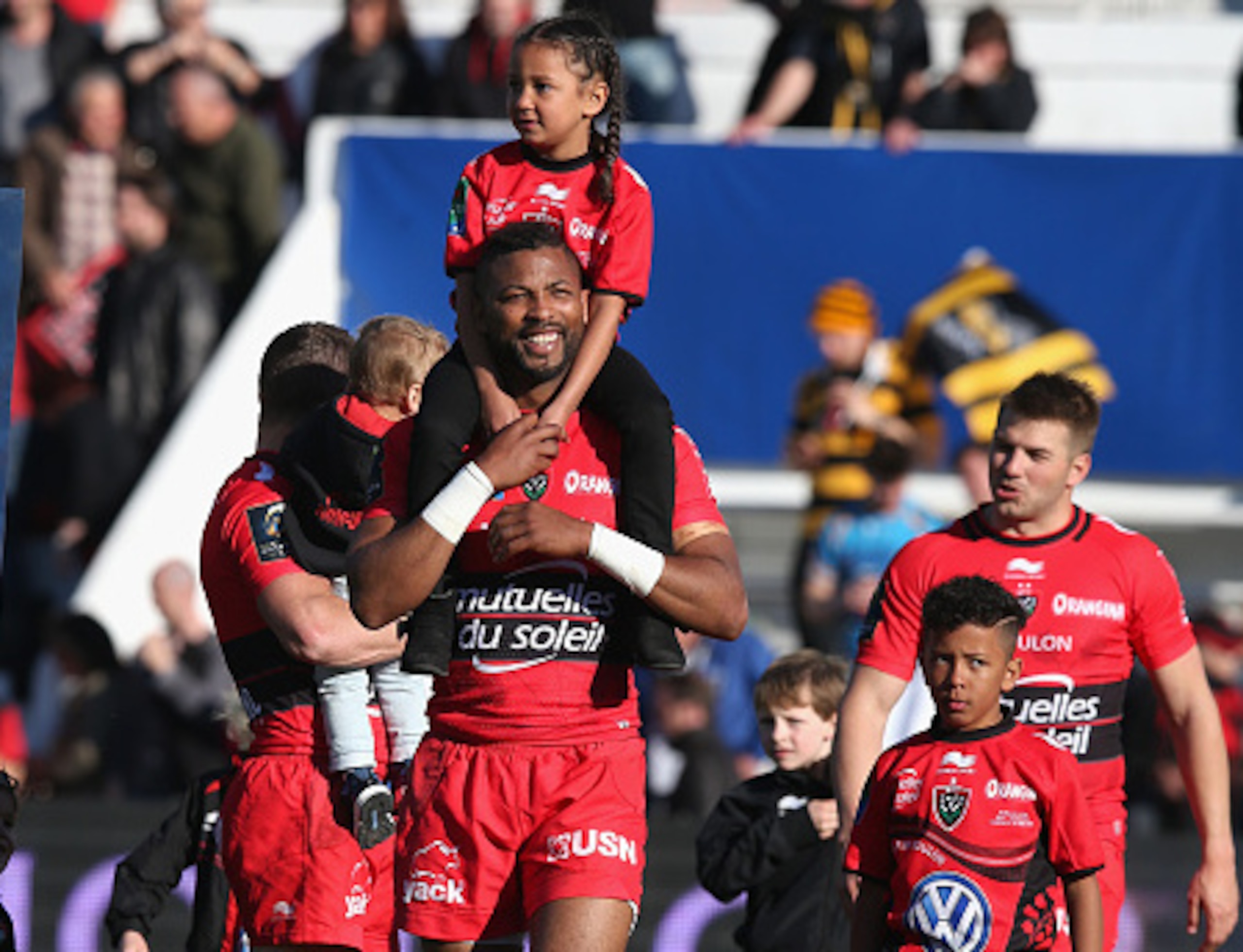 TOULON, FRANCE - APRIL 05:  Delon Armitage of Toulon celebrates with his children after their victory during the European Rugby Champions Cup quarter final match between RC Toulon and Wasps at the Felix Mayol Stadium on April 5, 2015 in Toulon, France.  (