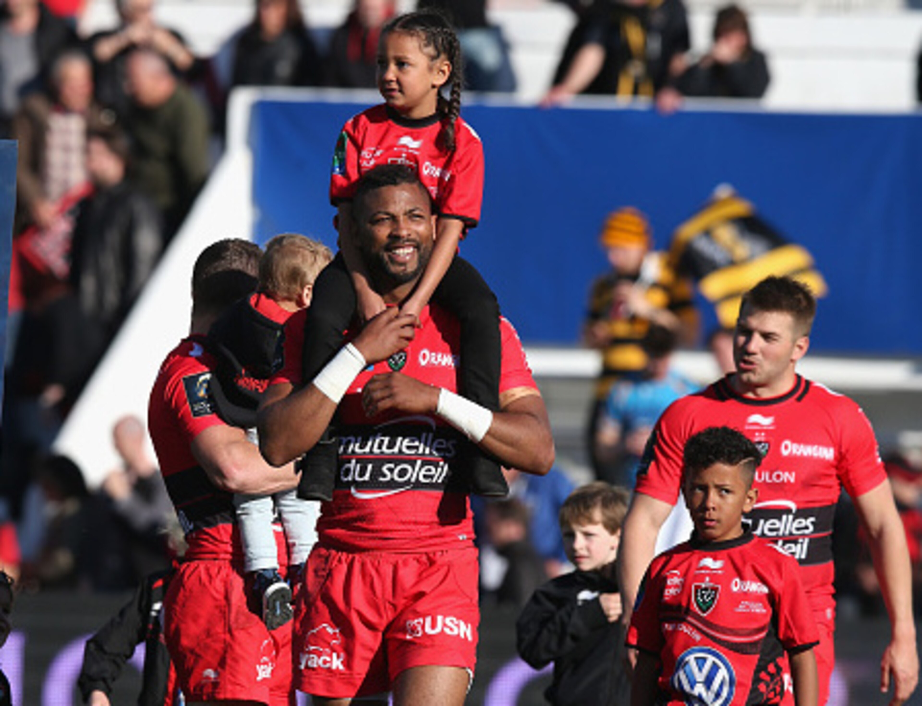 TOULON, FRANCE - APRIL 05:  Delon Armitage of Toulon celebrates with his children after their victory during the European Rugby Champions Cup quarter final match between RC Toulon and Wasps at the Felix Mayol Stadium on April 5, 2015 in Toulon, France.  (