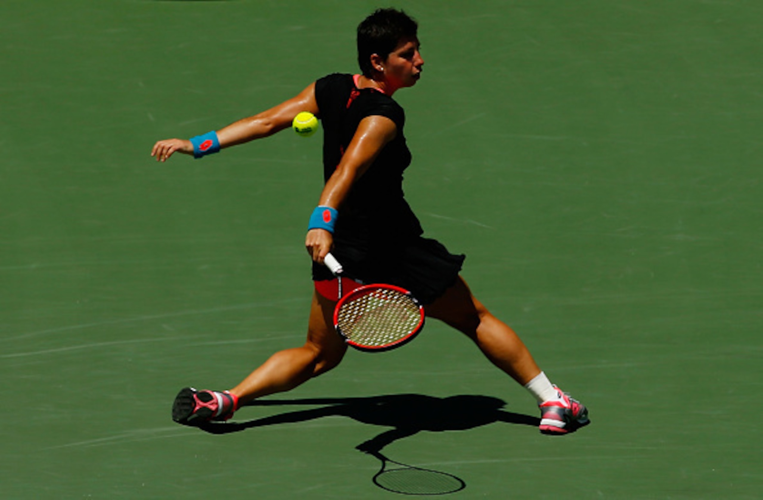 Carla Suarez Navarro glides into a backhand slice during her match against Serena Williams at the 2015 Miami Open.