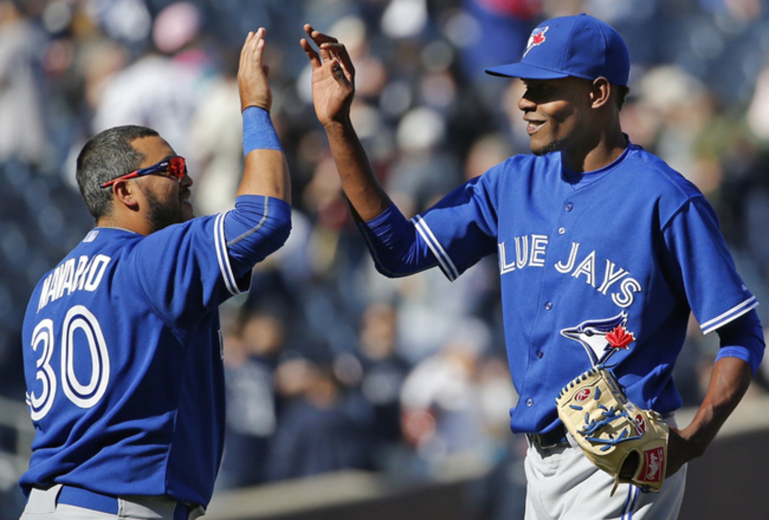Dioner Navarro and Miguel Castro celebrate the 20-year-old reliever's first career save.