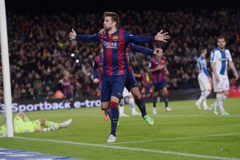 Gerard Pique celebrates a goal against Barca's cross-town rivals.