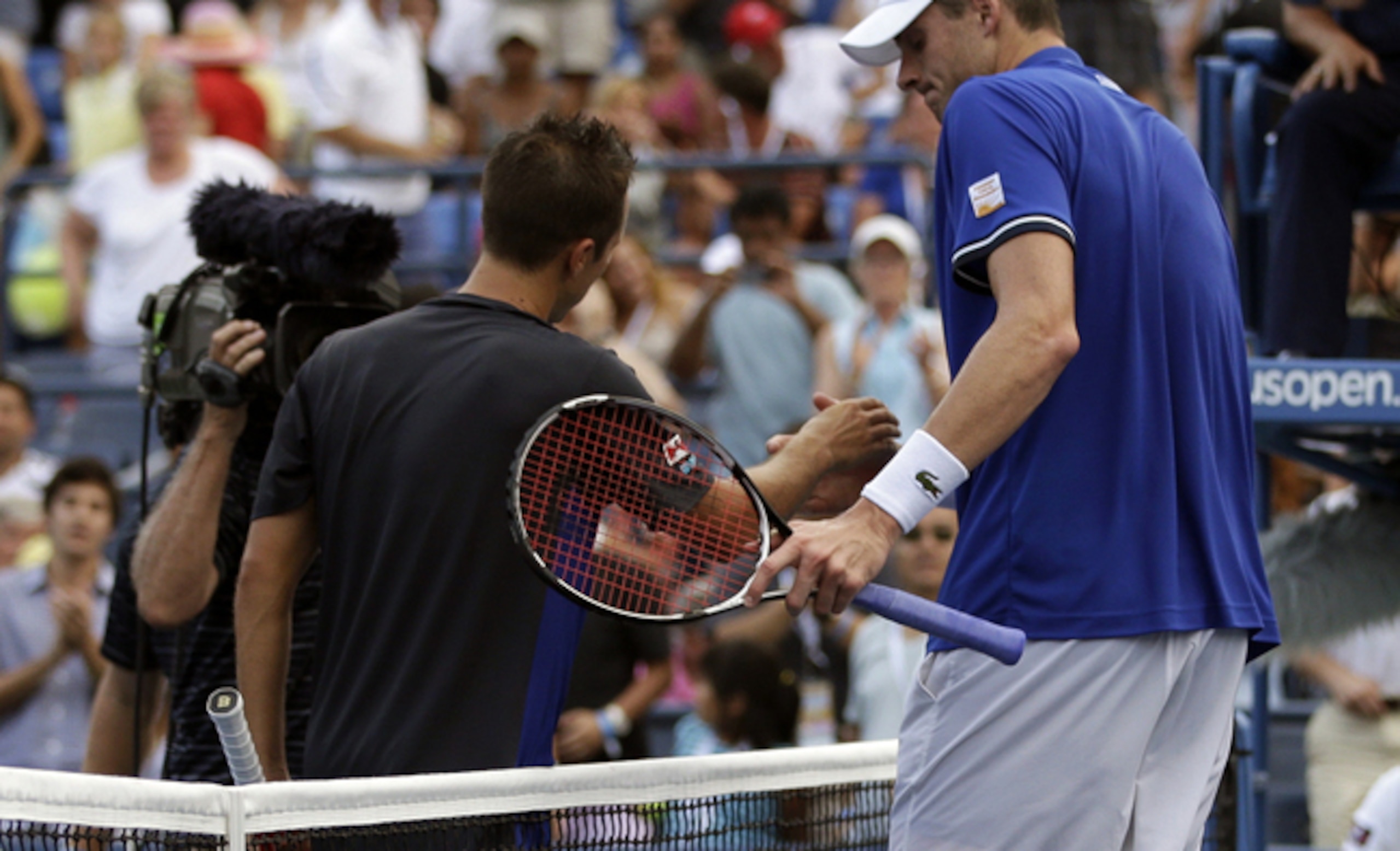 Philipp Kohlschreiber and John Isner shake hands at the 2013 U.S. Open.