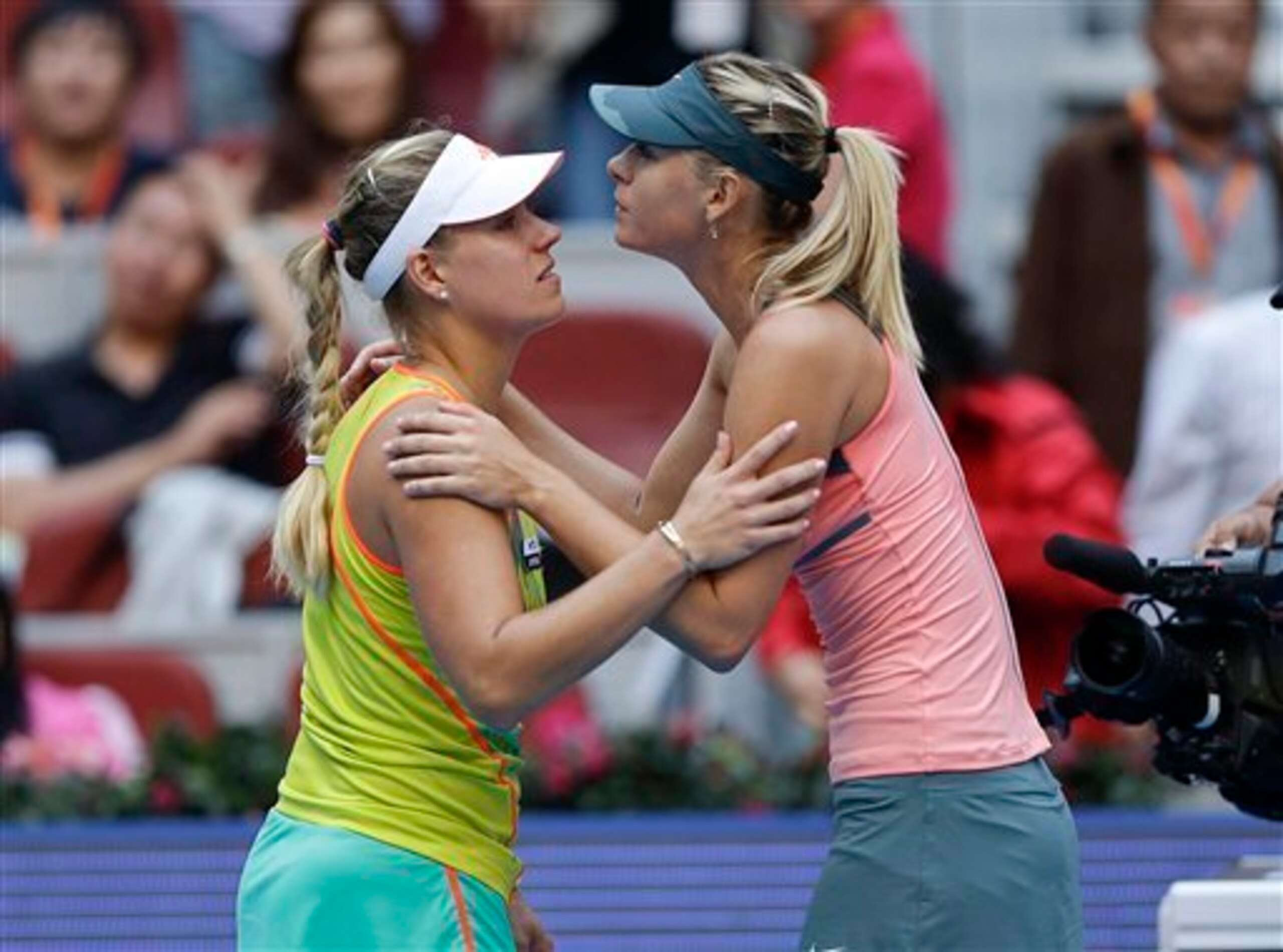 Angelique Kerber and Maria Sharapova in a post-match exchange at the 2012 China Open.