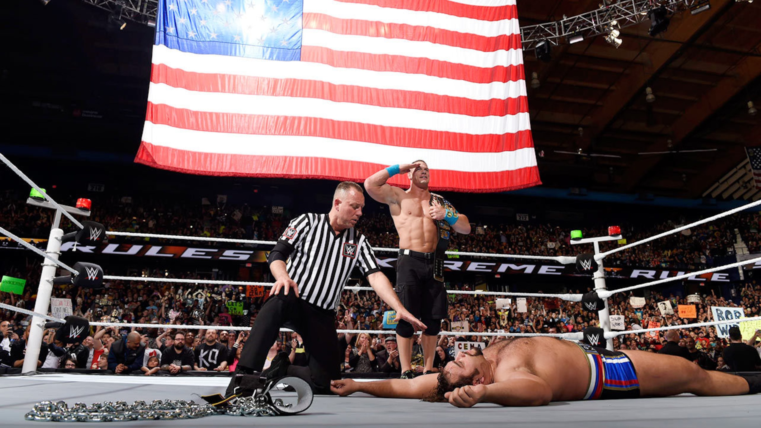 John Cena celebrates a win over Rusev.