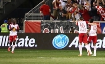Bradley Wright-Phillips walks toward Sacha Kljestan and Lloyd Sam to celebrate his second goal of the match.