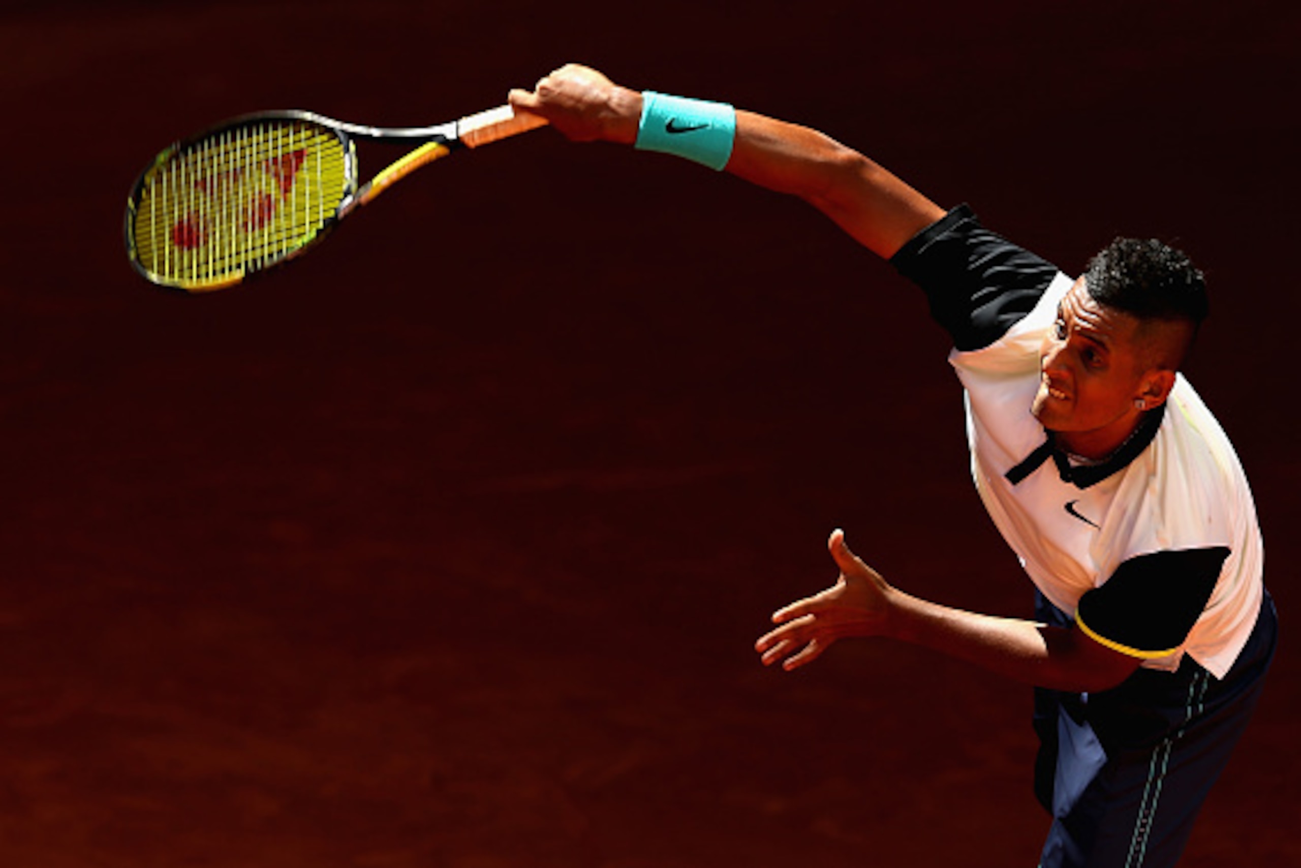 Nick Krygios serves during a match at the 2015 Mutua Madrid Open.