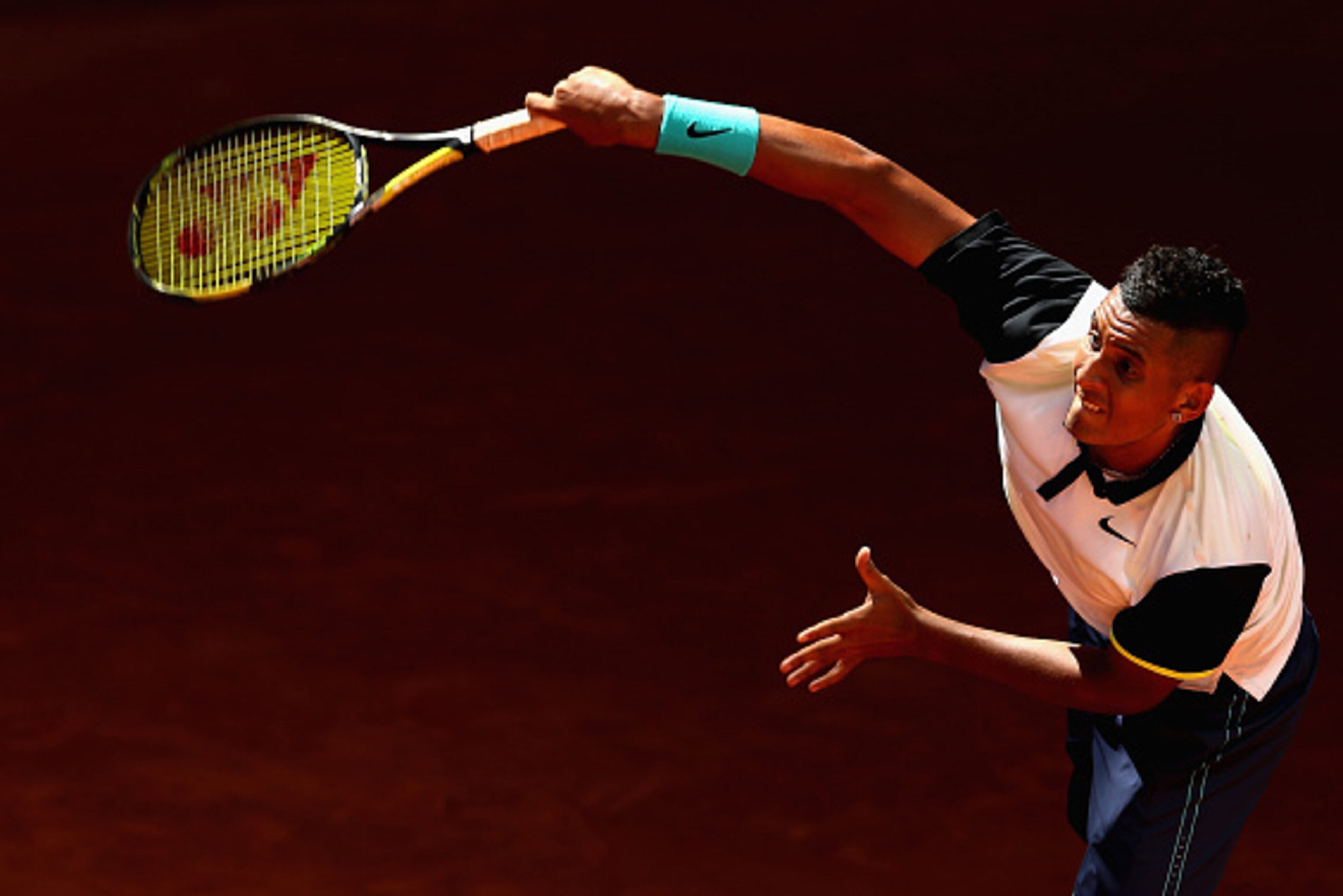 Nick Krygios serves during a match at the 2015 Mutua Madrid Open.